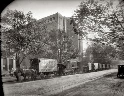 Washington, 1920. "Smith Storage Co., 13th &amp; U Streets N.W." With the motor truck gaining fast on the horse team. National Photo Company. View full size.
A. C. Smith: Mambo EnthusiastWashington Post Sep 25, 1955 


First Sold Flavored Snowballs, but This Was Too Seasonal
 By Eve Edstrom

Forty-five years ago, Arthur Clarendon Smith went into business with four horses, two open-top feed wagons and $400 which he borrowed from his wife.
Today the assets of Smith's Transfer and Storage Co. are placed at $1,500,000. The firm has 200 employees, operates a fleet of 52 motor vehicles, owns six modern fire-proof warehouses and that slogan: "Don't make a move without calling Smith's."
At age 72, the founder and owner of the moving company still works from 8 a.m. until 6 p.m. daily, never takes a vacation and never intends to retire.
His success secrets are simple: Take a 15-minute nap twice a day, leave liquor alone and vote the Democratic ticket.
... by the time he was age 10, he was in business, selling flavored snowballs for a penny apiece.  This business was too seasonal, though, and his next venture was raising guinea pigs.  His father soon offered him more money, 50 cents a day, and he went to work for Clarendon Smith's wholesale grain and feed company at 5th and K sts. nw.
The alert Arthur wasn't long in noting there was a great need for adequate means of transporting grain.  More important, he was convinced that horsedrawn vehicles soon would be a thing of the past, that motor trucks would benefit a transfer business.
So in 1910 he founded the Greater Washington Express Co.  The first three years were not happy ones financially.  As Smith recalls them, he was best by fires, thievery and payments of fines to the Humane Society. ...
In 1916 Arthur Clarendon Smith recognized the advantages which would result from operating storage facilities in conjunction with the growing transfer business. ....
Immediately after World War I, father and son set out to build a large fireproof storage warehouse.  Construction of their main building began with only $10,000 in working capital.  In 1920, it was opened at  1313 U st. nw.  Valued at more than $300,000 today, it is the hub of all the firm's activities. ...
A vigorous man who smokes continually, Smith plays just as hard as he works.  Currently, he and his bridge of almost 49 years are mambo enthusiasts.

Horse HockeyI really hope those 3 horses weren't responsible for the pile of rubble beneath the trucks in the middle of that parade.
Is this it?I took a walk down that part of town today.
This building looks a bit like it, but is on U St. between 14th and 15th (not 13th as in the caption).
There are just enough differences between the photos to make me wonder, but it seems like the only similarly-size building in the area.

(Also, no horses now.)
Smith Storage Revisited
1920 photo of Smith Storage, next to the U Street Oyster House. Click to enlarge. Below, an Aug. 24, 1919, news item.

Smith Storage Co. Expands
Work on Big $140,000 Fireproof Warehouse
To Start This Week.
Plans have been completed by the Smith Storage and Transfer Company for the erection of a big six-story fireproof storage and warehouse at 1307 U street northwest, to cost $140,000. Work on the structure will begin this week.
The building is to be of reinforced concrete, with metal partitions, doors, rooms, walls, etc. It will have a frontage on U street of 70 feet, and depth of 120 feet. The architectural design is to be unusual, the barnlike effect usually noticeable in buildings of this character to be avoided, and the front having what might be called a mission in Spanish effect. ...
Ready to show off.The wall doggers have the building lettered, and all the vehicles are lined up for the shot in front of their proud new facility.  It appears the one truck backed into the spot over the huge pile of horse apples. While I'm sure they wanted those gone for the shot, I have every confidence that the street sweeper was avoiding that block!
[That's dirt from taking a tree out its hole in the sidewalk. - Dave]
Fidelity Storage CompanyNice to see the photo of Fidelity Storage. The Building is still there at 1420 You Street NW but the company has changed hands many times since my Dad and Uncle sold the business in 1958. Started by my Grandfather, James L. Karrick, in 1905. I still have a miniature wooden mothproof rug storage chest from the company.
Fidelity Storage, 1420 U Street NWThe color photo in an earlier comment shows 1420 U Street, Fidelity Moving &amp; Storage, still in operation in 2016 as Extra Space Storage. Extra Space bought Storage USA circa 2005 and at that time began updating the property interiors, including replacing the original freight lift on the east side of the building. The elevator housing is seen on roof, the left edge of the photo. Up until then, the  freight lift was in regular use and available to customers to operate themselves.
Light and installation artist Rockne Krebs and painter Sam Gilliam once owned the adjacent warehouse building next door. It is now Goodwood, a furnishings and home design shop.
Other artists in the immediate neighborhood included Franklin White, James Wells, Alma Thomas, and many younger artists of the 80s and 90s.
In the 1980s Treto Way,  the large alley running from 14th street to 15th street was an open air drug market. In recent years, artists living in alley building behind U Street struggled with the developers of the Louis luxury apartment building, eventually winning some concessions but losing others to protect light and access to their property.
(The Gallery, Cars, Trucks, Buses, D.C., Horses, Natl Photo)