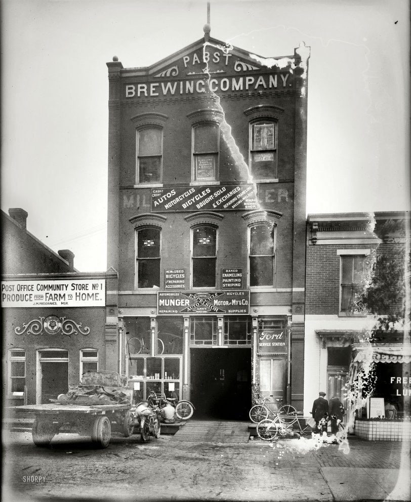 Washington, D.C., circa 1920. "Munger Motor &amp; Mfg. Co., front." On the minus side of the ledger, this glass negative has light leaks, dirt, mold and probably halitosis. On the plus side we have beer, motorbikes, circus posters and Freedom Lunch. This circa 1890s Pabst brewery on North Capitol Street would be returning to its beverage roots (minus the alcohol) in just a few years as the Whistle Bottling Works. National Photo Company Collection. View full size.
