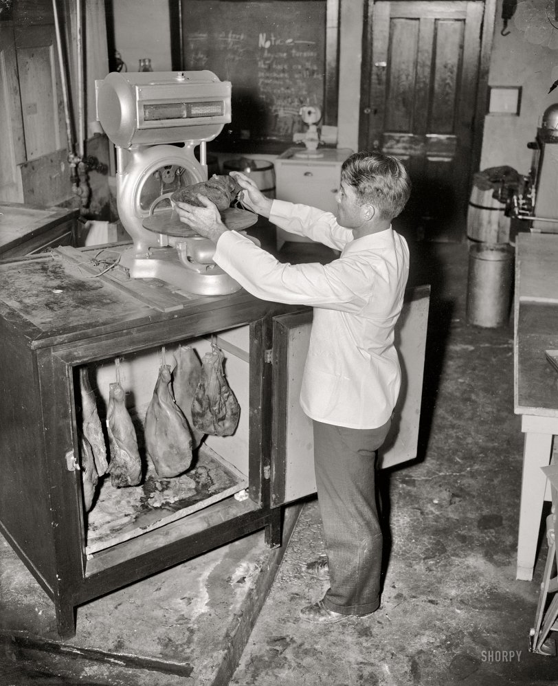 1937. College Park, Maryland. "Hams. From time to time the hams are taken from the incubator by Mr. Carroll and weighed to check the shrinkage caused during the aging process." Harris &amp; Ewing Collection glass negative. View full size.
