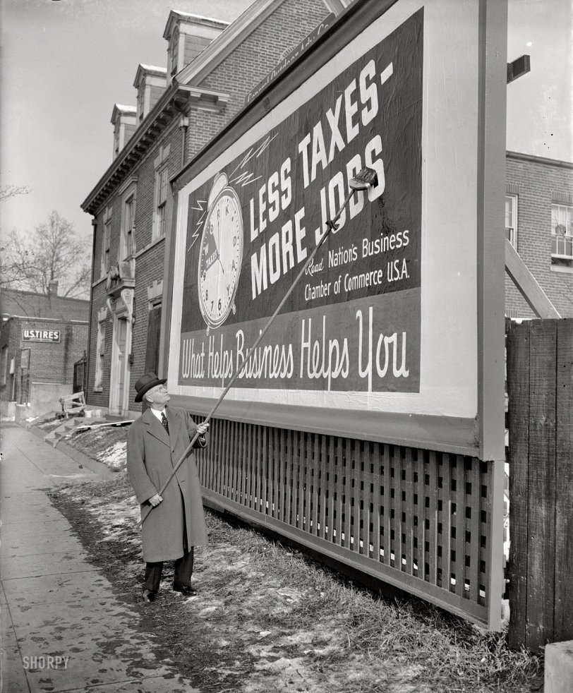 January 18, 1939. Washington, D.C. "'Less taxes, more jobs' reads the poster being pasted up by George H. Davis. It is the first of 25,000 such signs which will be put up all over the nation as part of a drive for reduction in taxes by the U.S. Chamber of Commerce. President Davis called in the photographers today to see the first one done right." Harris &amp; Ewing Collection glass negative. View full size.
