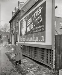January 18, 1939. Washington, D.C. "'Less taxes, more jobs' reads the poster being pasted up by George H. Davis. It is the first of 25,000 such signs which will be put up all over the nation as part of a drive for reduction in taxes by the U.S. Chamber of Commerce. President Davis called in the photographers today to see the first one done right." Harris & Ewing Collection glass negative. View full size.