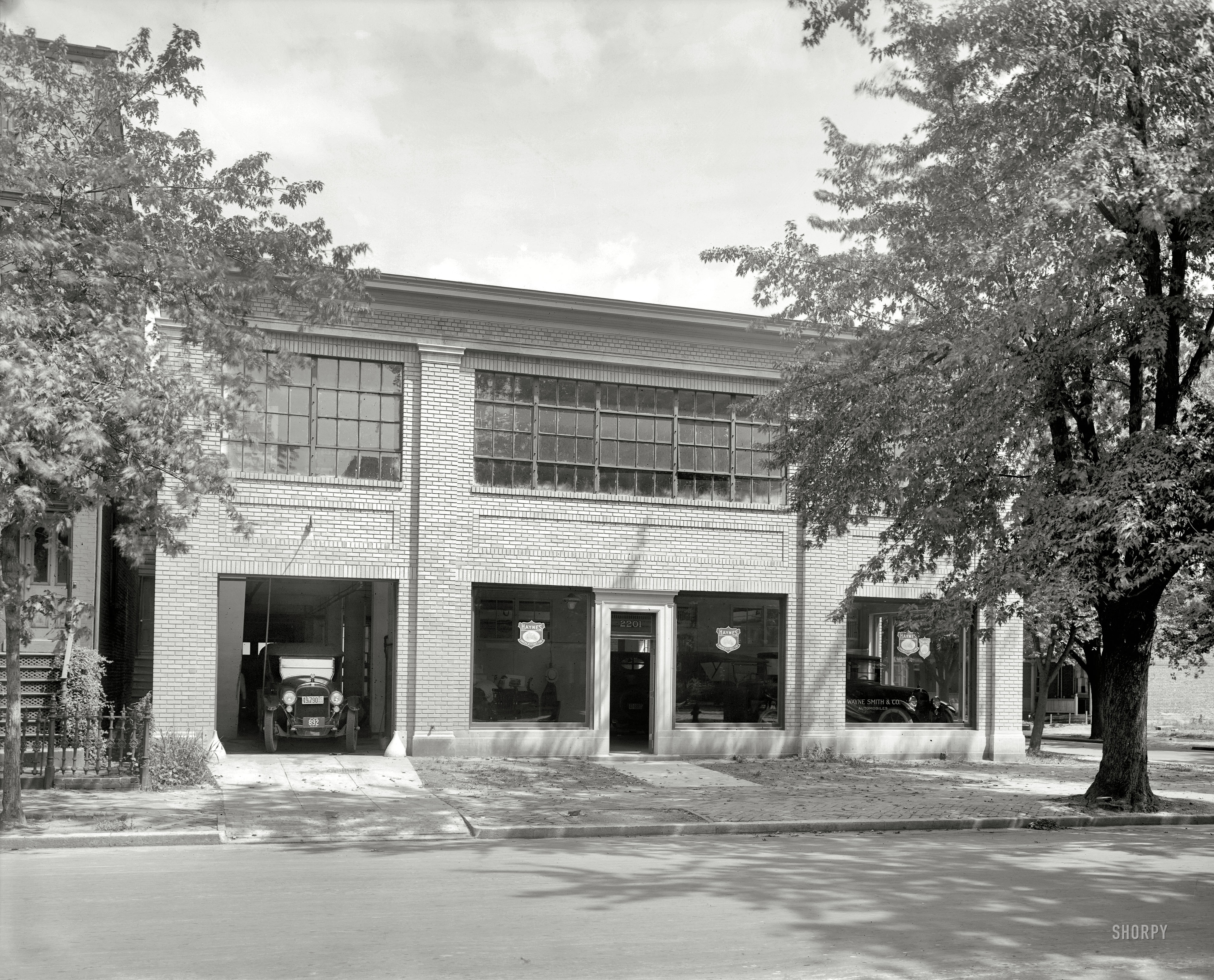 "Wayne Smith Auto Co., front." Mr. Smith went to Washington, and built this dealership at the corner of M and 22nd. A street view of the building shortly after its completion in 1920. National Photo Company glass negative. View full size.