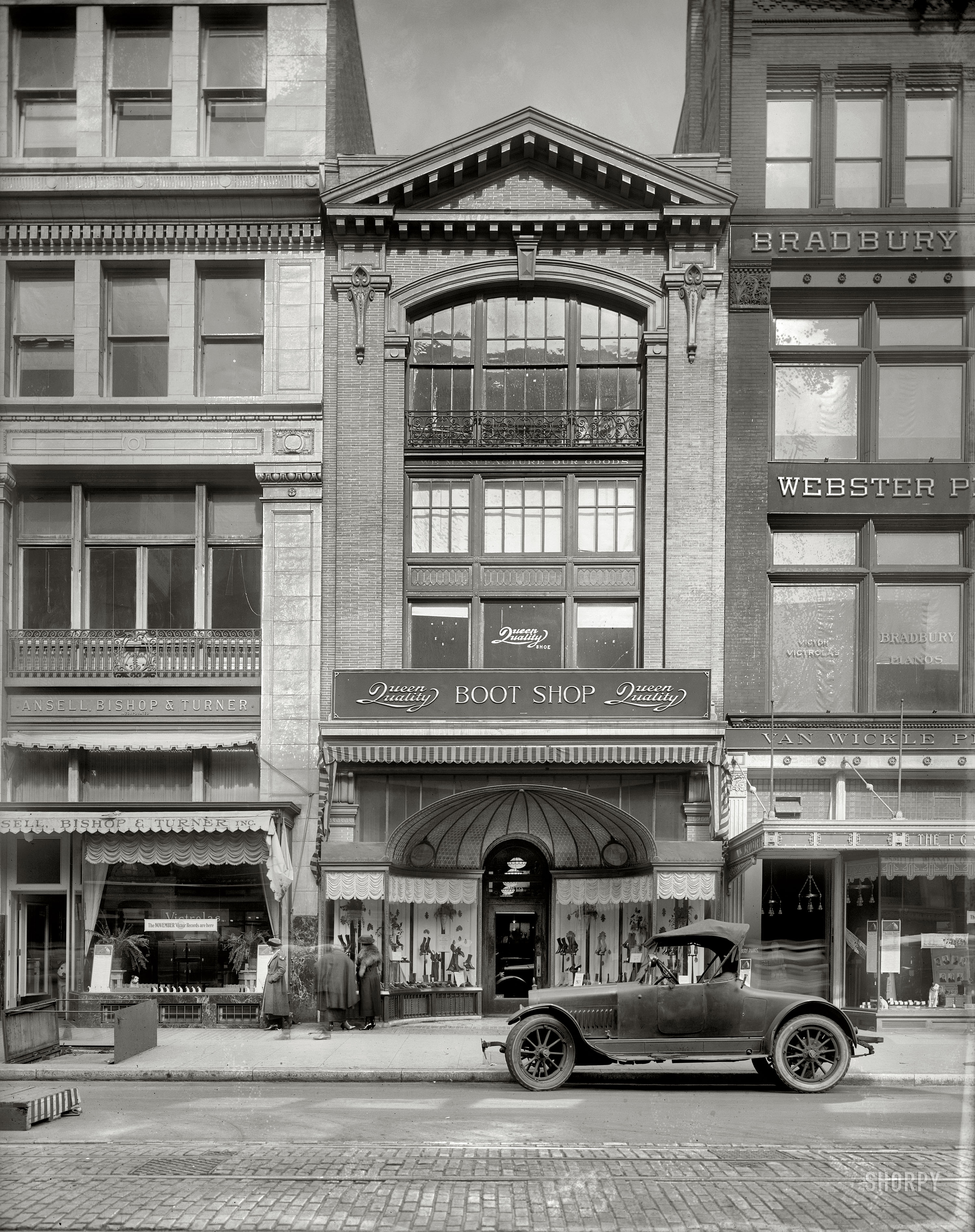 Fall 1920. Washington, D.C. "Queen Quality Boot Shop, F Street N.W." Flanked by Victrola stores and a multiplicity of Nippers. National Photo Co. View full size.