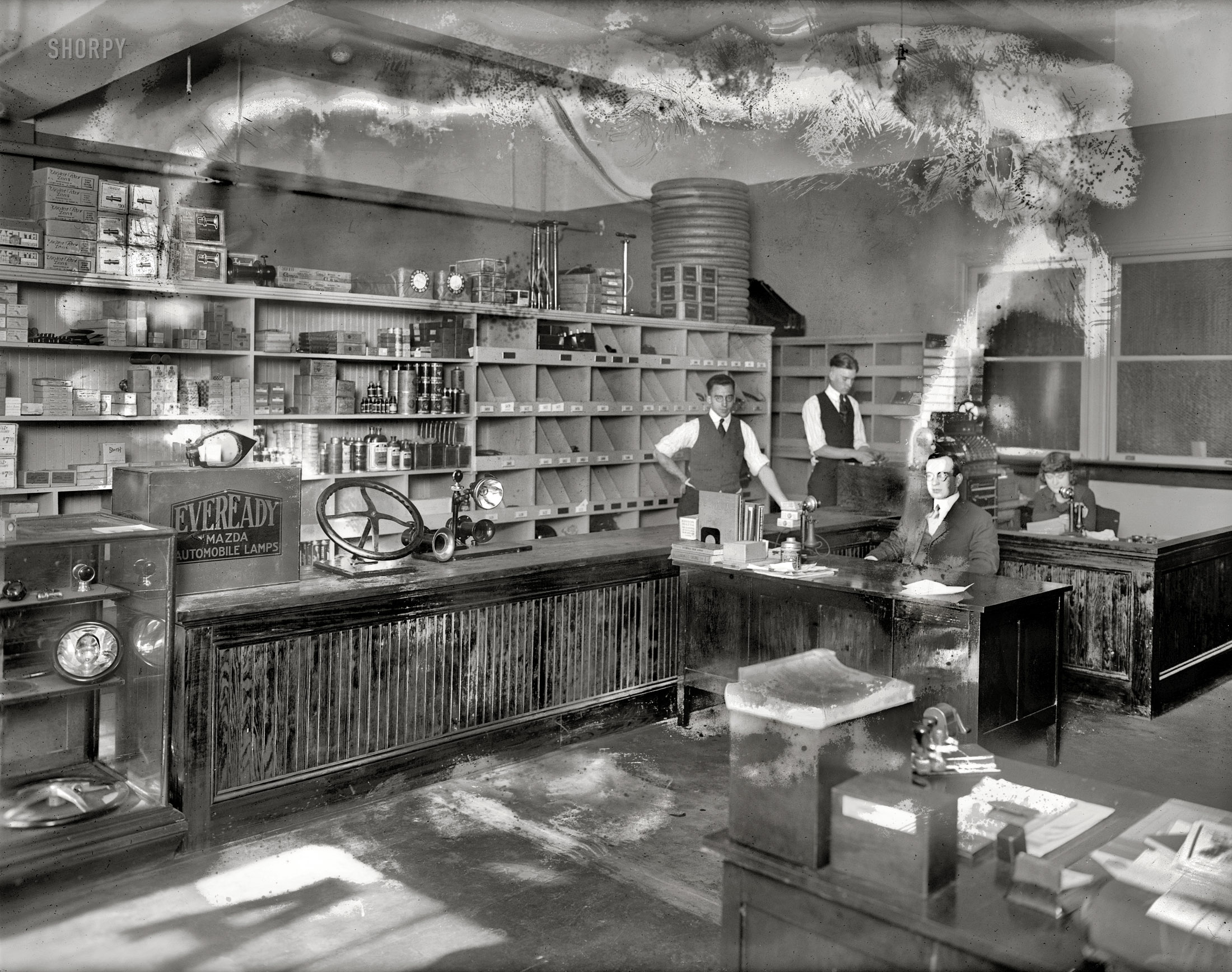 Washington, D.C., circa 1920. "Universal Auto Co., interior." The parts of old, beset by mold. National Photo Co. Collection glass negative. View full size.