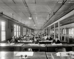 Washington, D.C., circa 1920. "Internal Revenue income tax story." National Photo Company Collection glass negative. View full size.
Obviously not summerAll of the windows are closed. All of the fans are motionless and unplugged.
Everybody seems to be wearing wool coats and ties.
Wait, that last bit doesn't mean anything!
Fall AsleepAs someone who works in finance, I can tell you that I would be asleep after 25 minutes of working like that. I need to have a radio on to work. So what does this office need? A Victrola with headphones by each desk.
What would happenif I were there to accidentally turn on the sprinklers??
(The Gallery, D.C., Natl Photo, The Office)