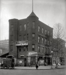 "Standard Engraving Co., Minster Building, 12th Street N.W." circa 1920. National Photo Company Collection glass negative. View full size.
12th and PennsylvaniaBased on ads in the Post, the location appears to be the southwest corner of 12th and Pennsylvania Ave, NW. - across the street from the Old Post Office and now site of Federal Triangle.  Minster's Corner was operated by Samuel D. Minster.  Washington-Virginia Railway was located at 1202 Pennsylvania.
 Washington Post, Mar 30, 1902

I have purchased the old reliable and long-established business of H.A. Seligson; 1200 and 1202 Pa. ave. nw., and have added to the already superb stock of Wines, Liquors, Cordials, and Cigars...  One of the distinctly new features of the establishment will be the attendence of lady clerks for the ladies' trade.

Eldorado Wine Co., Samuel D. Minster, Prop.,
S.W. Cor. Pa. Ave and 12th st. N.W.

 Washington Post, Jun 30, 1904

The National Association of Stationary Engineers, No. 7, met at its hall, at Pennsylvania avenue and Twelfth street northwest, Tuesday night .....

Stationary EngineersTo head off the inevitable questions, stationary engineers supervise engines in a fixed location such as in power plants, factories, mines, water pumping stations and so forth, as opposed to marine engineers or locomotive engineers. I believe the current union calls itself "Operating Engineers" which includes what we used to call building supers.
Your Weight and FortuneIs that a fortune-telling, penny weight scale outside the door of the Fussel's ice cream store? No wonder the place went out of business.
Stationary EngineersFor those of you who live in the country or exurbia and maybe even suburbia, a stationary engineer, to those of us city folk, is usually the building superintendent, or as we know him (or her), "the super".
Electric carsVery interesting to find out that, even in such a late time as the 1920s (when this photo is dated), there was still possible to get a ride on an electric car. One can only wonder what would have happened if those had caught on for public transport; maybe we wouldn't be choking in as much smog as today.
[They did catch on. They were called streetcars. In this instance, "electric cars" were the interurban trolleys of the Washington-Virginia Railway, departing from Mid-City Terminal at 12th and Pennsylvania. - Dave]

Bon-AmiWhen I was growing up in NYC back in the '50s, it was common for landlords to apply a film of Bon-Ami window cleaner to their rental store's front windows and door whenever it was vacant or during refurbishing, as is the case in this photo. I've not seen it used in years and don't even know if Bon-Ami is still sold. Thanks for jogging a nice bit of wistful memory for me.
Bon-AmiYes, Bon-Ami is still available.  It is the only scouring powder we use.  I buy it at the grocery store.
Non-IntoxicatingReif's Special was a short lived non alcoholic beer type drink.
Non alcoholic sodas gained in popularity after prohibition in 1916.
Reif's Special, described as "A Pure Liquid Food", was manufactured in Chattanooga, TN by Martin Lynch in 1917.

[advertisement text]
Reif's Special
Serve Cold
It Is Not A Compound
Here is the triumph of man's inventive genius - just
what the world has long been awaiting - a beverage
that has all the snappy flavor and foaming goodness
of the hops with the alcohol left out. That's done by
a patented process. We are the pioneers. Beware of imitations.
At soft drink places - in bottles or cases.
Martin-Lynch Co., Distributors
Carrie Nation&#039;s FrolicMinster's Corner was once the focus the famed Carrie Nation's ire.

Washington Post June 14, 1907 


Mrs Nation fined $25
Saloon Smasher Pays Up After Temperance Lecture to Judge

Mrs. Carrie Nation's frolic in front of S.D. Minster's store, at Twelfth street and Pennsylvania avenue northwest, Wednesday night, cost her $25 in Police Court yesterday.  Incidentally, and as a self-administered balm to her outraged feeling, the former Kansas hatchet wielded read from the witness box passages of Scripture touching upon intemperance.  Blackstone, as interpreted by Judge Mullowny, did not appeal to Carrie. Neither did her Scriptural readings to the judge, whose calm, judicial reasons was:
"I find you guilty of disorderly conduct, as charged.  Twenty-five dollars fine, please."
Mrs. Nation's friends made up the $5 additional to the $20 which she deposited in the First precinct station for the appearance in court.  The saloon wrecker departed, after discoursing freely as to the evils of strong beverages and cigarettes.

Mount Vernon RailwayThis building was the office and station of the Washington, Alexandria and Mount Vernon Railway, an interurban road that had a loop terminus in front of George Washington's Mount Vernon estate. The circular concrete drive in front of the main gate was once the railway right-of-way. Electric interurban cars pulled up alongside the awning in the photo for passengers.
Frank R. Scheer, Railway Mail Service Library
Carrie NationThe Washington Post article cited below is dated June 14, 1917, and the story appears to be reported as current news. Yet all three links for more Carrie Nation information give her date of death as 1911. Hmm...
Once again Shorpy piques my interest, and I learned something today about the history of the temperance movement and Mrs. Nation.
[The date on the news clip was a typo. It's from 1907, not 1917. - Dave]
Holmes PiesIs that Holmes Pies any chance the precursor of the Helms Bakery trucks with the slide out trays of bread, donuts and pastries which I recall roaming the neighborhoods of my youth in the western states? They disappeared in the 60's or 70's, as I recall.
[I don't know about Helms. But Holmes Bakery had its own fleet of trucks [Link 1] [Link 2] [Link 3]. - Dave]

No Sherlock, HolmesIt just dawned on me that it was the Helms Bakery that had those panel trucks that went around the neighborhoods. I think it was the burgeoning supermarket industry that did them in, just as with the home milk delivery boys. Obviously, a Sherlock I was not when it came to Holmes Pies...
(The Gallery, D.C., Natl Photo, Stores & Markets)