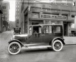 Washington, D.C, 1921. "Scripps-Booth Sales Co., 14th Street N.W." And one very shiny sedan. National Photo Company Collection glass negative. View full size.
Scripps-Booth HybridThe 1913 Scripps-Booth Bi-Autogo, a 3,200-pound motorcycle-roadster with a steering wheel and V-8 engine. It never took off.
Piano FinishHow did they get that car to shine like that?
I see London, I see FranceI see the Photographer's Pants, and some of the Tripod. 
If he had left the window up we could see the rest of him.
That Mirror FinishThis Scripps-Booth was no doubt painted with DuPont's new lacquer, Viscolac, which was introduced in 1921.  It was the predecessor of DuPont's famous Duco automotive lacquer. Both Viscolac and Duco could be rubbed out to a beautiful mirror-like finish.
Is it a &quot;1920 Velie Six&quot;OK, I think the car with the suicide doors is a "1920 Velie Six." Am I close? I thought Essex for awhile.
[It's a Scripps-Booth! - Dave]
Paint jobHand rubbed lacquer.
Boring!Now, if you could only find a picture of the Scripps-Booth Rocket...
Scripps-Booth PricingScripps-Booth autos appear to have been built to appeal to a consumer mindful of fuel costs (lightweight frame, economical engine).   Is the pictured vehicle an example of a luxury appointed 1920s American econobox?  




Washington Post, May 29, 1921.


Scripps-Booth Passenger Cars

"The Utmost in Light Weight Construction."
Touring Car: $1295
Roadster: $1275
Coupe: $1950
Sedan: $2100
F.O.B. Factory


Scripps-Booth six-cylinder, valve-in-head passenger cars are noted for their beauty, distinctiveness, durability and economy of operation.

They are a General Motors Product
Scripps-Booth Sales Co., Inc.
1012 14th Street N.W.
Franklin 5831


Scripps-Booth Near Its EndScripps-Booth assembled its last cars in 1922 with leftover parts, around a year after this picture was taken. By that time it had become a fairly ordinary car. 
Some of the earlier models were rather unusual (first as lightweight cyclecars; later as full-sized cars with V-8 engines, etc.) and innovative for their time. By 1919, shortly after becoming part of General Motors, Scripps-Booth cars became fairly conventional and were based on GM's Oakland (the forerunner of Pontiac) chassis.
The paint finish used on the pictured 1921 Scripps-Booth would most-likely have been a japan or varnish-based paint.  The first production car using lacquer was, ironically, the Oakland, in 1924.  It featured Dupont's Duco, a nitrocellulose lacquer that saved the carmakers weeks of paint-drying time and the space needed to store the drying bodies, which then had to be tediously hand-polished before final assembly.
Incidentally, I have a picture of the 1914 Scripps-Booth Rocket, Tandem Roadster, but, unfortunately, since my scanner landed on the floor a few days ago, I can't submit the image.   
The brakes!The keen buyer will notice the generous-sized contracting band brakes - operating on the rear wheels only! Guaranteed to stop you in less than 250 feet from 30 mph!
Car OpenersNote how those suicide doors are aptly equipped with hearse handles!
1012 14th Street NWView Larger Map
Mary, fire up the DeLoreon!I want to go back in time with a couple of thousand dollars and buy one of these new. I could resell it and pay for both kids' college educations and pay off my house!
These are relatively expensive cars for the time.  A Model T was about $600.00 at the same time.
Typo!That should be MARTY, fire up the Deloreon!
[Ahem. "Deloreon"? - Dave]
Old car pricesI own a 1919 Scripps-Booth, these don't go for Duesenberg prices. Rare doesn't equal expensive. Most cars of this era are actually relatively affordable, going for about the same price as a mid-range new car. Although SBs are rare (we have 50-100 still remaining), by 1918 or so they are almost identical to Oaklands and Buicks of the same year. I actually think all of that's a good thing, because I can use my car and enjoy it. While I can't go to NAPA to buy parts, there are enough owners of similar cars so I can get replacements for some things.  
(The Gallery, Cars, Trucks, Buses, D.C., Natl Photo)