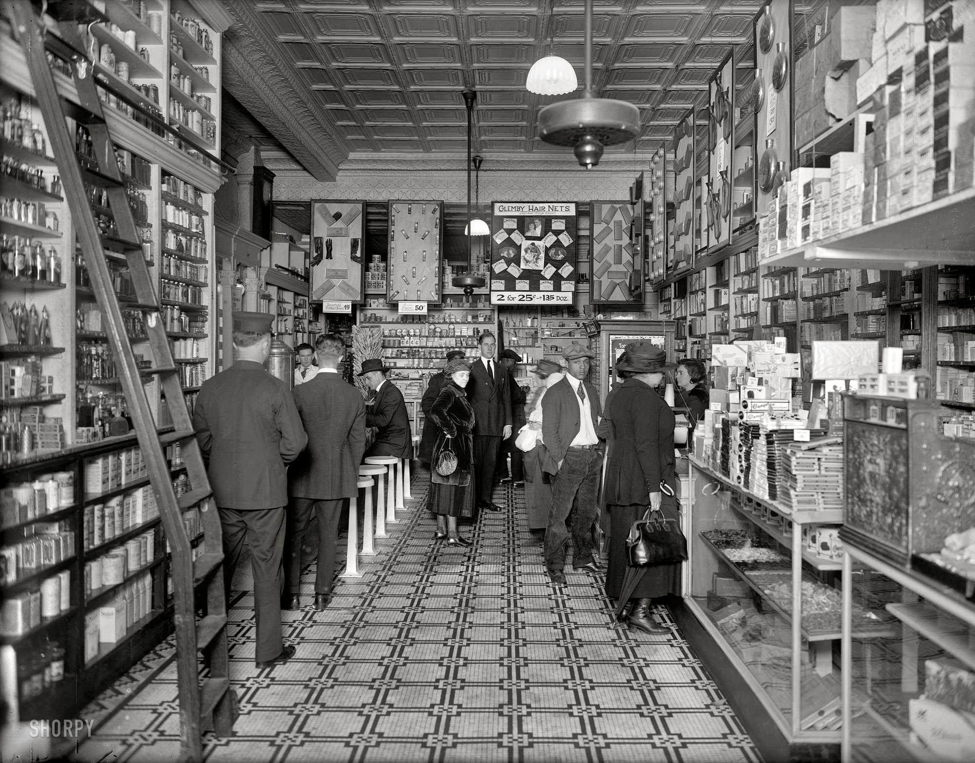 Washington circa 1920. "People's Drug Store, interior, 14th and U streets." We're happy to report that this branch upholds People's reputation as a purveyor of such household essentials as Glemby Hair Nets, hot water bottles and scary black rubber gloves. National Photo Company glass negative. View full size.