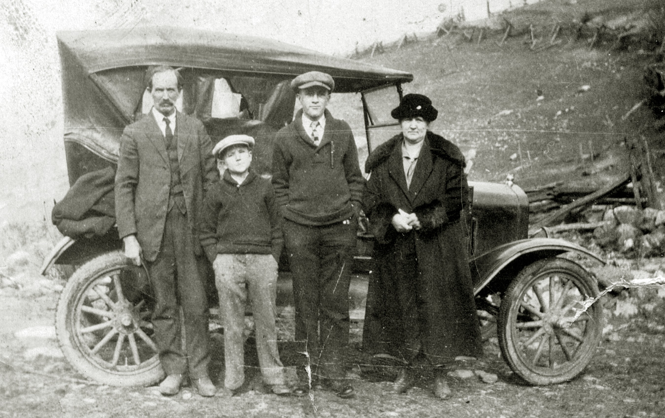 James Vincent Campbell and family (Maynard, James, and Mollie). Photo taken in Russell County, Virginia, circa 1924. Can anyone identify the car? View full size.