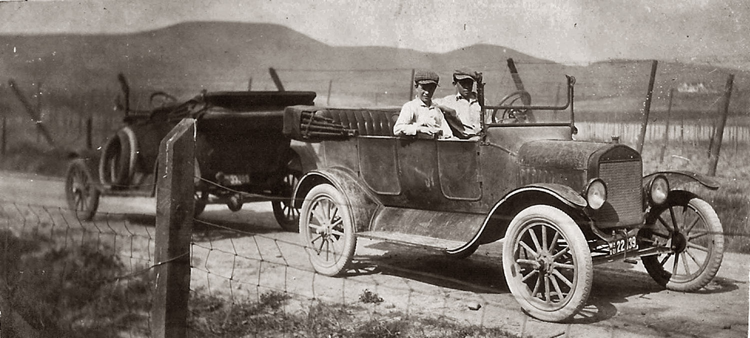 This came from my grandparents' photos, most likely taken in Yakima Valley Washington. Not sure who it is. The lc plate is 1921. The cars are Ford "T"s.