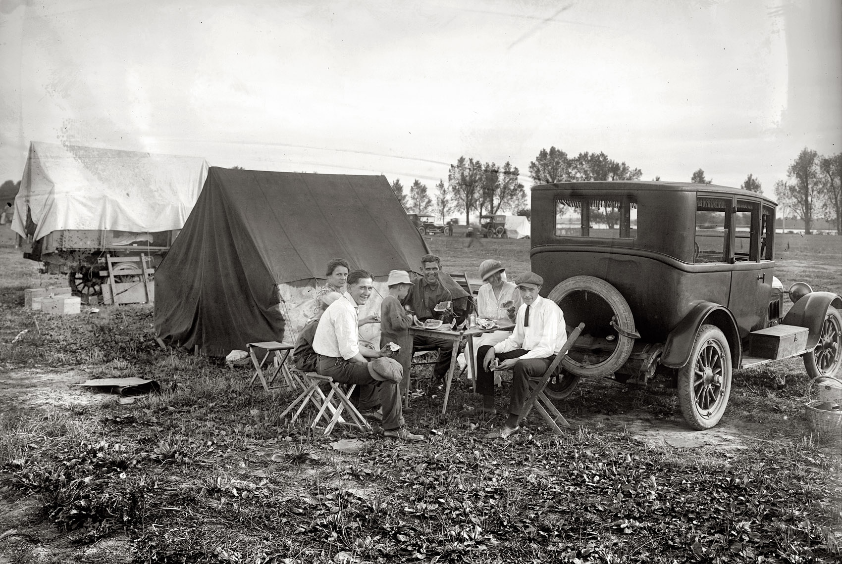 "Tin can tourists. 1921 or 1922." Car camping and watermelon in or around Washington, D.C. National Photo Company glass negative. View full size.