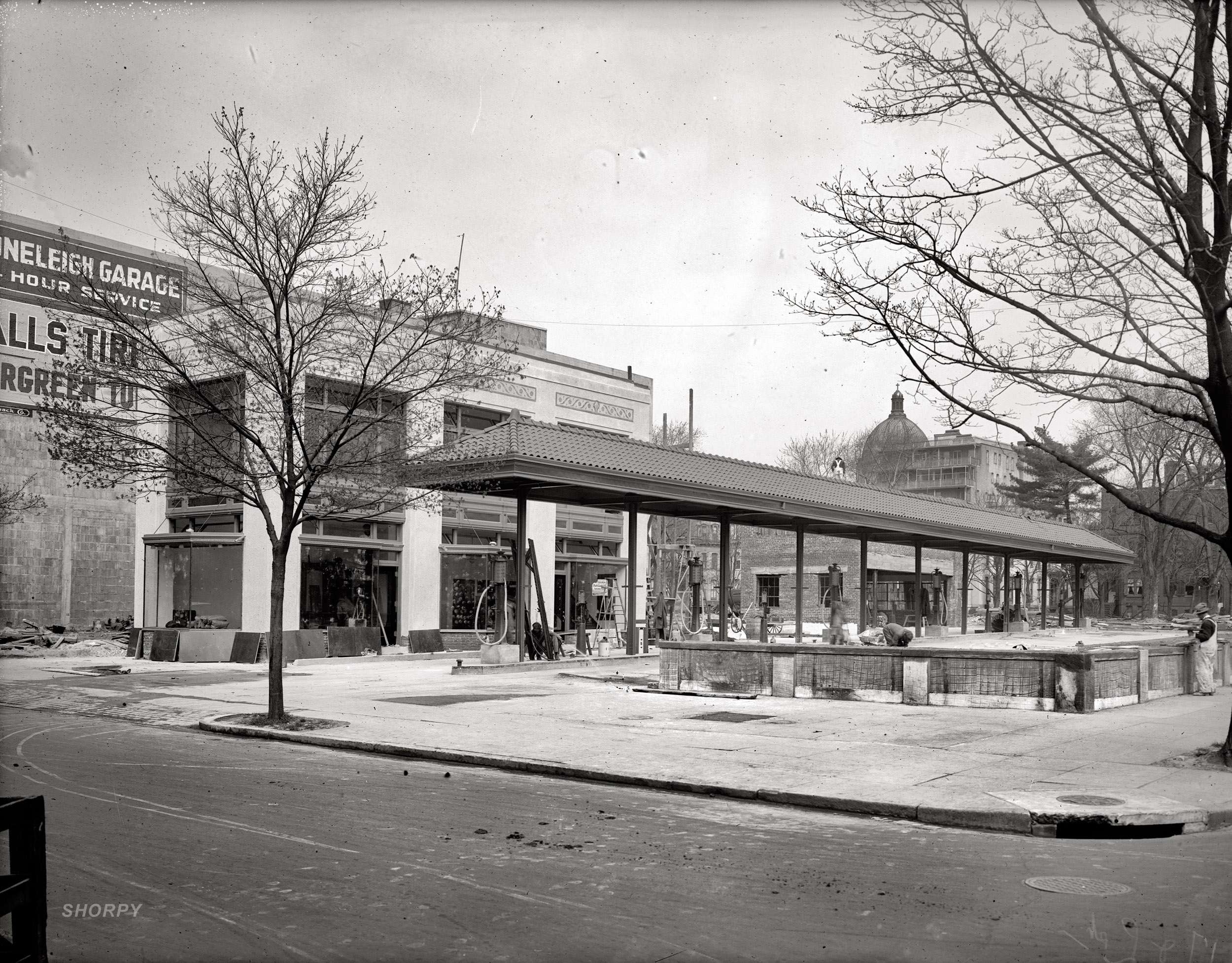 "Filling station, 17th & L." The Washington Accessories Co. service station under construction at 1703 L Street N.W. in early 1922 next to the Stoneleigh Garage. National Photo Company Collection glass negative. View full size.