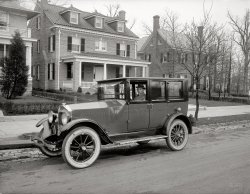 Washington, D.C., circa 1921. "Dunigan auto." The residential developer D.J. Dunigan with some of his creations. In back is the house we saw earlier today. The car is a circa 1921 Velie Six. National Photo Co. glass negative. View full size.
Velie sedanI think the car is an early 1920s Velie, a car made in Moline, Ill., by a cousin of John Deere, who invented the steel plow. Closed sedans were a luxury in the early days when most cars were open tourings or roadsters.
It might be a GardnerThe car looks like a 1920 or 1921 Gardner sedan, but I'm not positive.
Car IDI win! That's old man Dunigan's car.
The new closed VelieVelie seems to be the correct answer. This car had hundreds of ads in the Washington Post from 1910 to 1928. Maybe D.J. saw it on display at the Wardman Park Hotel "Closed Car Salon" -- click below to enlarge.

Velie MotorsVelie built 250,000-300,000 cars from 1909 until 1928, of which a couple hundred still exist.
The company also built aircraft and aircraft engines for several years. Its airplane business was sold and moved to St. Louis after Velie Motors closed, building Monocoupes until 1950 or so.
Velie Motors ended production of automobiles in 1928, a year before the death of company founder Willard Velie, a grandson of John Deere.
The front wall of the old Velie Carriage Works is all that remains, incorporated into the perimeter around the John Deere Planter Works on River Drive in Moline.
Where the streets have no nameThese look like good, solid houses that should still be around, so I went hunting on google/bing maps but came up empty. 
Of course, numbered streets in DC are totally bizarre (18th, for example has a NE, NW and SE, and they start and stop and random locations), so it's not exactly simple. I don't envy the Washington postal carriers.
[The ever-resourceful Stanton Square found these houses on 16th Street NW in the previous post. - Dave]
Edit: Ah, thanks, missed that. They sure look smaller now than the old pix, but in nice condition.
View Larger Map
Love to find the car today.....Being able to see the house 82 years later via something that was never even dreamed is just beyond NEAT!
Love this website!
Why two?Ok, so it is a Velie, but why are there 2 license plates on the front and back?
[Back before the reciprocity laws, motor vehicles had to licensed in every state they were driven in. - Dave]
NomenclatureHow neat that the two door Velie sedan was known as the "Sociable Coupe"! I wonder if it had a bar in the back?
How gaucheIf there's anything I can't stand, it's dirty whitewalls.
Scary windowsThe cottage for sale has those scary quarter-round windows that will forever haunt me from the Amityville movies.
NeighborsI live two blocks from these houses. They're bigger than they appear, around 2,500 square feet and still in great shape.
(The Gallery, Cars, Trucks, Buses, D.C., Natl Photo)