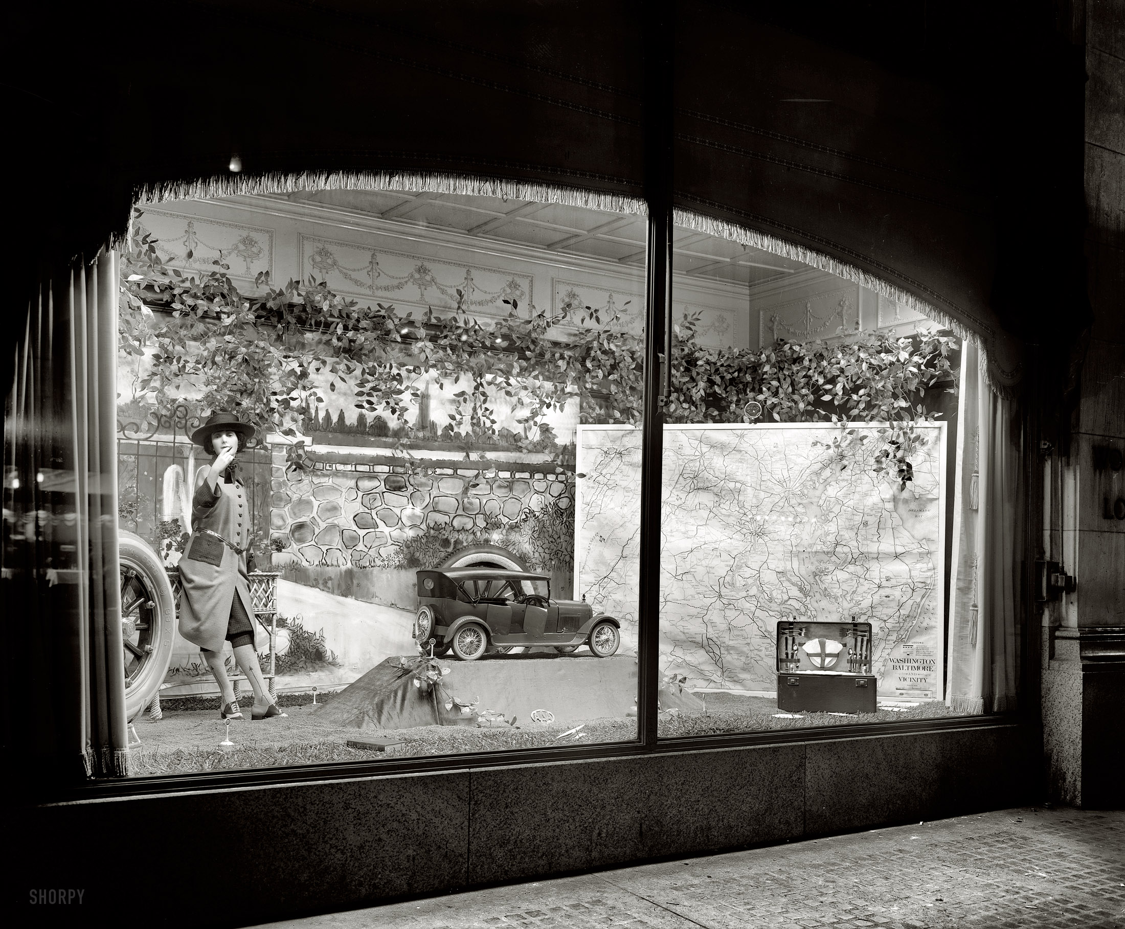 Washington, D.C., circa 1921. "Woodward & Lothrop window." Department store display with a motoring theme. National Photo glass negative. View full size.