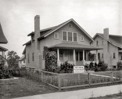 Washington, D.C., circa 1921. "1804 Kearney Street N.E." If only these walls could talk. National Photo Company Collection glass negative. View full size.
Yard SpaceWhile not huge per se, it's a heck of a lot more than the current homes in gated developments are given in SW Florida these days. Literally, reach out and touch your neighbor. Thank GOD for my acreage!
 Good NewsThe owner had gotten a big raise and was moving into a larger, more comfortable house.
1804 in 2009Probably the house.
View Larger Map
If these walls could talk...They'd be hard to understand. I'd worry more about them falling down -- they're all plastered!
Asa B. MustainAttorney at Law
Born December 3, 1879
Died March 6, 1962
What else do we know about his long life?
Err...1804 in 2009Although the Google Streetview addresses are not always reliable, it seems that this dwelling is more apt to match the historical photo.  Counting from the corner it is the third building (1800, 1802, 1804) and despite the lack of front porch, all the windows match.  Plus, note the roof-line of the dwelling to the right.
 (Map of Shorpy architecture in Washington, D.C.)
View Larger Map
1804 ! 1804 is the white house with no porch. Go to Street View of 1800/1802 and pan over the side yard to 1804. You can see the dormer behind the chimney.
DC Real Estate records:
Building Type    	   Single
Building Style 	1.5 Story Fin
Living Area 	1,488
Year Built 	1921
Bed Rooms 	4
Bath Rooms 	2
1/2 Bath Rooms 	0
Total Rooms 	10
Wall 	Stucco
Floor 	Hardwood
Heat 	Hot Water Rad
Air Conditioning 	None
Fireplace(s) 	1
StuccoStucco was the aluminum siding of the 1910s and '20s. Many old houses that needed paint and repairs had the stucco job done right over the existing siding and shingles, many times multiple layers. And most of these jobs are still holding up today, 90 to 100 years later.
A big thanksA big thanks from me, to whomever is maintaining the Map of Shorpy Architecture on Google Maps.  Very cool.
(Is it you, Dave?)
[Who is Keeper of the Maps? "Stanton Square is Keeper of the Maps!" - Dave]

FOR SALEOdd that the sign has no phone number.  I guess the salesman knew "if you get 'em in the door, the sale is half done."
[Pop quiz: Who can tell us what the phone number is? - Dave]

And the phone number isMain 1790
That number againThat would be MAin 1790, or 62-1790
It was only about 25 years ago when I last used a 4-digit phone number -- in a small town where everyone had the same first three digits.
[Or would that be six-digit number? - Dave]
And the telephone number is...Main 1790.
Permit #1791804 was built on the same permit as the entire row of 1800-1814 Kearney Street NE. Permit #179, Sept. 9, 1919.
Quantity: 8 dwellings
26 feet wide
32 feet deep
Front material: stucco (so the stucco is original to the house, probably over metal or wood lath rather than over wood siding)
Heat: Hot water
Estimated cost: $48,000 (so $6,000 each)
Foundation: hollow tile (see Shorpy's photo of the Rhode Island Avenue police station from a few weeks back)
Roof material: composite shingle (yes, asphalt shingles have been around for almost 100 years)
Sarah, get me Yoda.My parents got their first telephone in 1947 in a very small town in Connecticut and had a three digit number, that was it, no area code, prefix or exchange.  I also lived in a very tiny village in Ohio that had its own operators (one on each shift), and only party lines were available.  The operator could tell you anything you wanted to know about anyone in the village, even where they were at that particular moment.  One person looking for me was told by the operator that I had been seen walking to the grocery store and would probably be home within an hour.  Ah, the good old days.
ThreadsOne of the joys of reading the various comments is how they can meander around.  This string has ventured into old phone number systems, all based on the incidental phone number on that real estate sign.  Wonderful.  You have to revisit photos and see where things have led.  I live in a small area where everyone has the same area and exchange numbers; you tell folks your number by just giving the last four digits. Makes it all seem smaller and more intimate. And neighborly.
Five-Digit Phone NumbersIn my home town of Rochester, Indiana we dialed 5 digit numbers right up through the 1970's because the exchange was the same for everybody in town.  Instead of 223-xxxx you could just dial 3-xxxx.  
Sarah, get me 3I used to work with someone, from an old and prominent Boston family, who told me his great-grandfather's phone number way back when was 3. I wonder if it was unlisted? Did Mr. Bell do the installation?
SevenMany years ago I met a man who was so old, his Social Security number was 7.
Telephone Exchange NamesI know this discussion happened almost 2 years ago, but in case anyone else comes upon this thread.
This is a great article that explains the exchange name system to the uninitiated. And this is a huge database of the actual exchange names and number systems in use for locations all over the U.S. - possibly international as well. 
(The Gallery, D.C., Natl Photo)