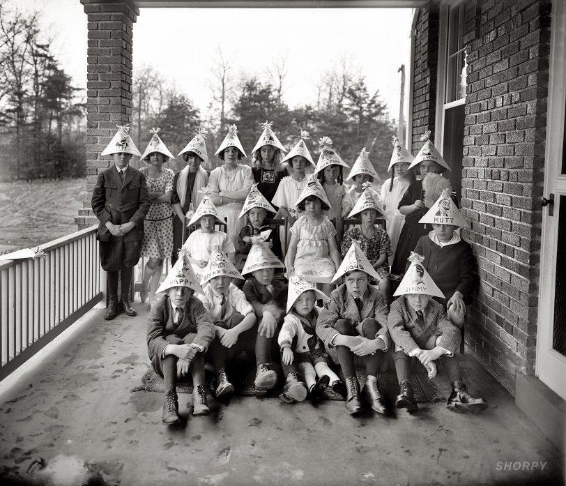 "John M. Bear Jr., 11/26/22." Twenty-one little kids. All wearing hats decorated with characters from the funny papers. At Johnny's 11th birthday party. And they're  mortified, every last one. (Thought you'd all slip under the radar, did you? That this embarrassing little artifact would just go on collecting dust at the bottom of a box somewhere? Well. Guess what. Not only did they invent radar, they invented computers and scanners and the Internet. Bwahaha. View full size!)
