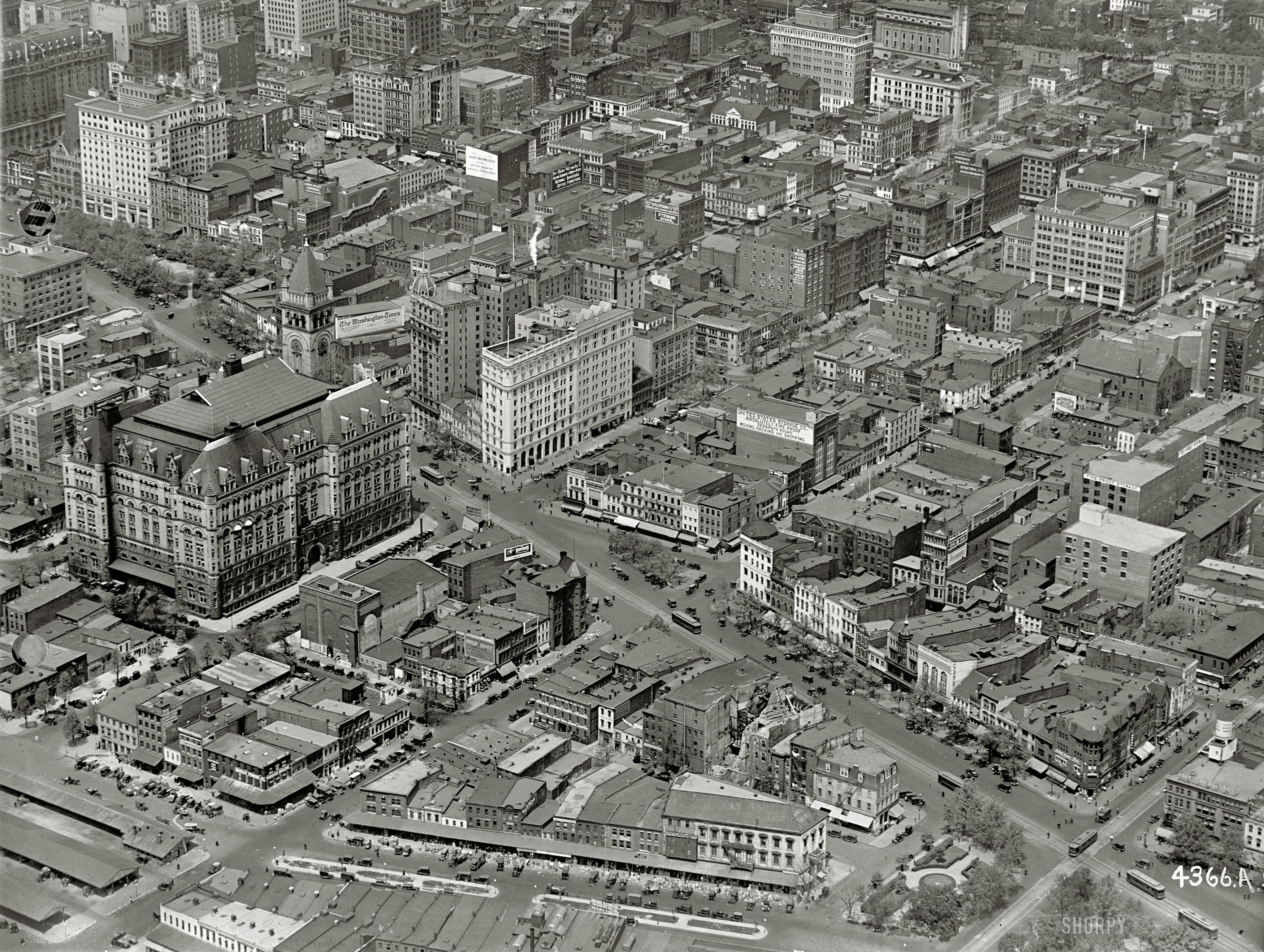 Washington, D.C., circa 1922. "Star Building from air." The Washington Star newspaper building at the center is at the intersection of 11th Street N.W. and Pennsylvania Avenue, which runs diagonally across the photo. The big building with the tower us the Old Post Office. There's a lot to see here, including laundry hung out to dry. National Photo Company glass negative. View full size.