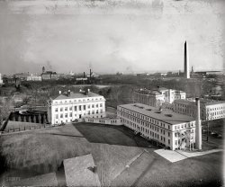 Washington, D.C., circa 1921. "Aerial view looking toward Capitol and Washington Monument." National Photo Company Collection glass negative. View full size.
An Eclipse of the EllipseWhat puzzles me is the photographer's vantage point.  No doubt it was from the corner of 18th and E Streets N.W., but was it from the roof of the Department of the Interior or a building that preceded it??
This photo looks to the east.  The white building to the left is the headquarters of the American Red Cross.  It's still there, but gone is the less-ornate wing to the right with its smokestack.  I believe that building was one of the infamous "temporary" office buildings of First World War vintage that were ubiquitous features of DC landscape up until the late 1960s.   The neighbor to the right is DAR Constitution Hall, which remains remarkably unchanged to this day.  Across the street, of course, is the Ellipse, which you can think of as the "backyard" of the White House.  Beyond the Ellipse are landmarks that need no introduction (the Washington Monument, the Old Post Office, the Capitol, Bureau of Engraving, etc.)  Perhaps another reader can verify that the two smokestacks just left of center belong to a Pepco generator that powered street cars.  Despite the haze, one can faintly see the arched roof of Union Station, appearing on the horizon to the far left.
[There was a tall brick building behind Red Cross HQ. Click below to enlarge. - Dave]

Ordnance OfficeBased on the bit of the 1919-1921 Baist Realty map below (click on it for a larger version), I would guess the photographer was on top of the Ordnance Office of the War Department.  It is puzzling that the angle of the photo does suggest quite an elevation and the ordnance office doesn't appear to be a large building: perhaps there was some sort of observation tower on top of the building.
The smokestacks in the distance are indeed the Potomac Electric Power Co. Plant at northeast corner of 14th &amp;B streets N.W.: they are also visible in the background of this Shorpy photo.
Also indicated on the map is the Frazee Potomac Laundry, seen here. 

(The Gallery, D.C., Natl Photo)