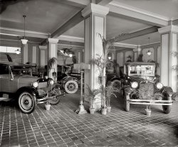 "Trew Motor Co. interior." Circa 1920, the Reo automobile showroom (and conservatory) in Joseph Trew's new three-story building at 14th and P Streets N.W. in Washington. National Photo Company glass negative. View full size.
Trew BuildingA 1923 Washington Post article says this building, then described as new, was at 1509 Fourteenth Street, the site of the present Studio Theater.
[Below, a 1920 article on the new building. - Dave]

Ransom Eli OldsREO: Ransom Eli Olds.  The Oldsmobile is also named after him. He, not Henry Ford, developed the first assembly line.

Anti-theft Potted PlantsMan, they sure were nuts about ferns and palms in the teens and 20s, weren't they? They were almost as much a part of the era's style as were fringy lampshades and ugly hats on women. (The lampshades could be on lamps or women&mdash;you pick.)
Reo SpeedwagonWhen I was a teenager in the 60's, my best friend's dad had a Reo Speedwagon, mid-1920s but not sure. It had a straight four, not the later six they came out with.  The two things I remember about it was it had exposed rocker arms above the engine head that were lubricated by drip cups. Before starting, a rocker valve was raised that opened the valve in the glass cups which "dripped" oil onto the rocker arms every few seconds. The other thing I remember was that the traditional H pattern of most floor shifts was mirror image. 1st was at the forward right, 2nd was back right, 3rd was left forward, etc. Made for fun shifting switching back &amp; forth between the Reo and my VW.
(The Gallery, Cars, Trucks, Buses, D.C., Natl Photo)