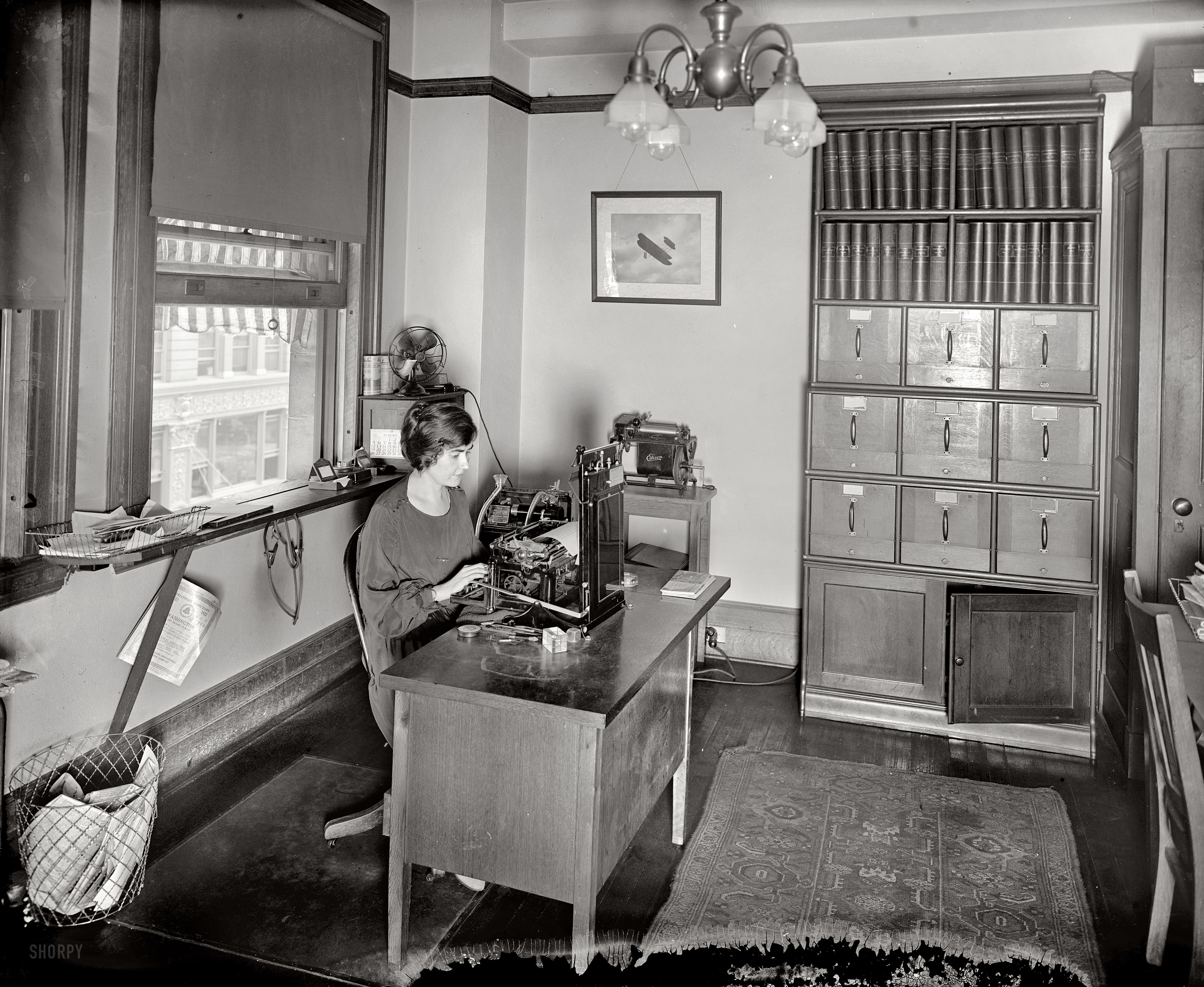 Washington, D.C., August 1923. "National Highways Association." An interesting variety of business machinery on display here including a Dictaphone and some Ediphone cylinders. National Photo Company glass negative. View full size.