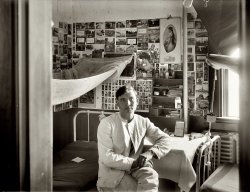 "Young man in dormitory room." More baseball cards. Our cadet/orderly/cook has calendars for 1910 and 1911 on the wall, and a crest for the Quartermaster Corps on the bed. Thanks to Kurt for suggesting this photo. View full size. National Photo Company Collection glass negative, Library of Congress.
The Middle ShelfIt looks as though the middle shelf of his desk has more of the postcards that he's papered his wall with. Based on the size of his pocket watch (on the next lower shelf) those shelves aren't very wide. There looks to be more Baseball cards on the shelf above.
I'm not sure if that's a toothbrush below the tooth powder cans. Somehow the size of the head looks to be too large - as large as his pocket watch. 
Note the whisk broom on his table; just the thing for brushing off a uniform. There are so many details about this picture that make you want to know more.National Photo suggests the Washington D.C. area; the decoration suggests permanent residence; the fact that it's not a large barracks room but rather just two beds in a small room suggests either a junior officer or an NCO (which his apparent age would argue against) but his clothing suggests something lower. Even the emblem of the Quartermasters Department (before 1912) on the bed doesn't tell us bis branch of the Army. Wouldn't equipment such as this, issued by the Department be marked in a obvious way to prevent theft?
Tiny FridgeThat shiny object next to his elbow resembles a tiny refridgerator. the guy looks like a medical intern/student.
[Back in the olden days, they called it a mirror. - Dave]
Baseball cards!It's too early for the Babe, but there could be a Ty Cobb rookie card on that wall. Either way I'd give my left arm for those cards!
This is an amazing photo.This is an amazing photo. Can anyone identify any of the players on any the baseball cards? This picture belongs in the collection of the National Baseball Hall of Fame in Cooperstown!
Mosquito nettingWhen was the last time you slept with netting on your bed? This was a time when we still had outbreaks of Malaria and yellow fever in this country. 
Kittens of Doom?The postcard in the top row, seventh over looks like it could be a Harry W. Frees picture of the "Kittens of Doom." Being pulled in a cart by what looks to me like a chicken? I am probably way off.
Cool picture though, we plastered our dorm room walls with tons of stuff too. Almost 90 years later... 
QM CorpsThe crest on the bed appears to be the insignia of the Quartermaster Corps: sword and key on a wheel, topped with an eagle. GI bed.

Hey JudeDoes this fellow remind you of Jude Law the actor? Great picture at many levels.
Sugar DaddySeen on the wall: I like this town. I think I'll buy it for you. 
Too funny!
PinupsThe thing that struck me immediately was the modesty of our cadet's pictures of ladies.  And yet, there they are, up on the wall for him to sigh over.
Collegiate SlobEvidently his RA never told him where the laundry room was. What, was he picking watermelons? Playing baseball?
Back in the olden days, they called it a mirror. - Dave
You're crackin' me up, man.
If You&#039;re a Man, Smile!What's on the wall. Click the image to zoom, then click a second time to expand.

Toothbrush/powderThe toothbrush looks rather well worn. Interesting containers for the toothpaste and powder.
And if you don&#039;t smile?Guess our friend is not-so-manly.
This IS an awesome post, Dave. Are those records in the middle shelf of his desk? I can't decide if that's what it is or just some papers/books.
[On the wall: "If you're a man, smile! If you're a dog, wag your tail." - Dave]
Dorm GuyI think the mosquito net is interesting. Tropical climes maybe.  Like everybody else, I would really like that baseball card collection.
Card IDThird card to the right of his left ear is 1909-1911 Chicago White Sox Doc White. From upper right, two down, four over is Frank Chance, Chicago Cubs, published by American Tobacco Company 1909-1911.
TyThat's Ty Cobb leaning on the can by the pole at the right.
Christy MathewsonA 1911 Christy Mathewson card is in the row above the whisk broom, 5th card from the right.
Cards Cont&#039;dMost of the cards to the left of this fellow are T 205 gold border cards, published by the American Tobacco Company in 1911.  The complete 208 card set can be seen here -- http://www.vintagecardtraders.com/virtual/t205/t205.html
The one leaning on the can is not Ty Cobb but Albert Bridwell, NY Giants --
 
I can ID most of the gold border cards.  Starting below the post card with the dogs, to the left of the calendar, the three portraits are (top-bottom) Owen Wilson, Pittsburgh Pirates; John J. McGraw, NY Giants; and Arthur Devlin, NY Giants.
Directly to the right, the four cards are (L-R) Larry Doyle, NY Giants; G. C. Ferguson, Boston Rustlers; Frank L. Chance, Chicago Cubs; and William A. Foxen, Chicago Cubs.
Farther right, three cards vertically (top-bottom) Arthur Fletcher, NY Giants; Charles E. "Gabby" Street, Washington Senators; the bottom one I have not been able to ID.
The five in full view to the right of the 'Ty Cobb' can (L-R) Christy Mathewson, NY Giants; Robert Ewing, Philadelphia Phillies; George Gibson, Pittsburgh Pirates; Frank L. Chance, Chicago Cubs; and Tony Smith, Brooklyn Superbas.
That is all.  Someone else do the rest!
This is a dorm room for sure...Girls on the wall, sports figures and not a book to be seen.
Gems"I love my wife, no more kids"
"I like this town, I'll buy it for you."
"We had a rompin' good time."
Positive ID?OK, I think I got the one T 205 I couldn't before (bottom card in the vertical set of three farthest right).  I believe it is Thomas J. Needham, Chicago Cubs. Other possibilities are Harry McIntyre, Chicago Cubs, or Ed Konetchy, St. Louis Cardinals.
  
CardsThe cards behind his head look like mostly t206 white border.  I see Josh Devore, Hal Chase, Red Ames, Ed Foster, Doc White, Christy Mathewson, Heinie Berger...
Burning Down the HouseIt just occurred to me that this fellow looks like David Byrne of Talking Heads.
i am entrancedThis is truly a fine and complex room. It radiates the personality of the occupant. Though he doesn't smile, his relaxed pose shows a humor that comes through in his eyes. The hands are clean and held in a "just ask me" clasp of slight composure. The ladies on the wall compete
with the ballplayers. As was a sign of the times. Influenza was out and about, as were malaria and encephalitis. Mosquito nets were a necessity everywhere.
My only big question is: Can you tell me about the 3rd large postcard or picture on the left?' It looks like Coronado Island of San Diego. I am sure I am wrong. Thanks for the excellent work on this Dave. It gave me introspection for my day of calamity (so far).
(The Gallery, Natl Photo, Sports)