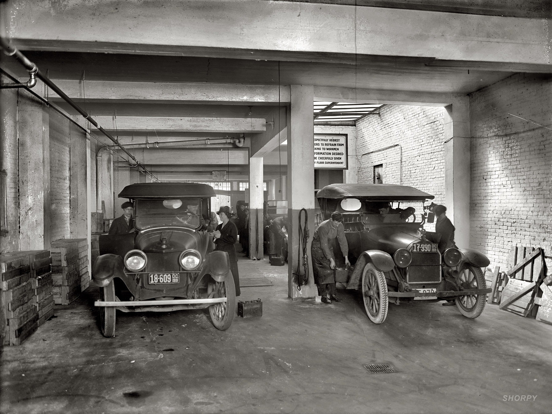 District of Columbia, 1919. Willard Service Station, Washington Battery Co., 1623 L Street. The sign: "We respectfully request customers to refrain from talking to workmen. Any information desired will be cheerfully given out by floor superintendent." National Photo Company glass negative. View full size.