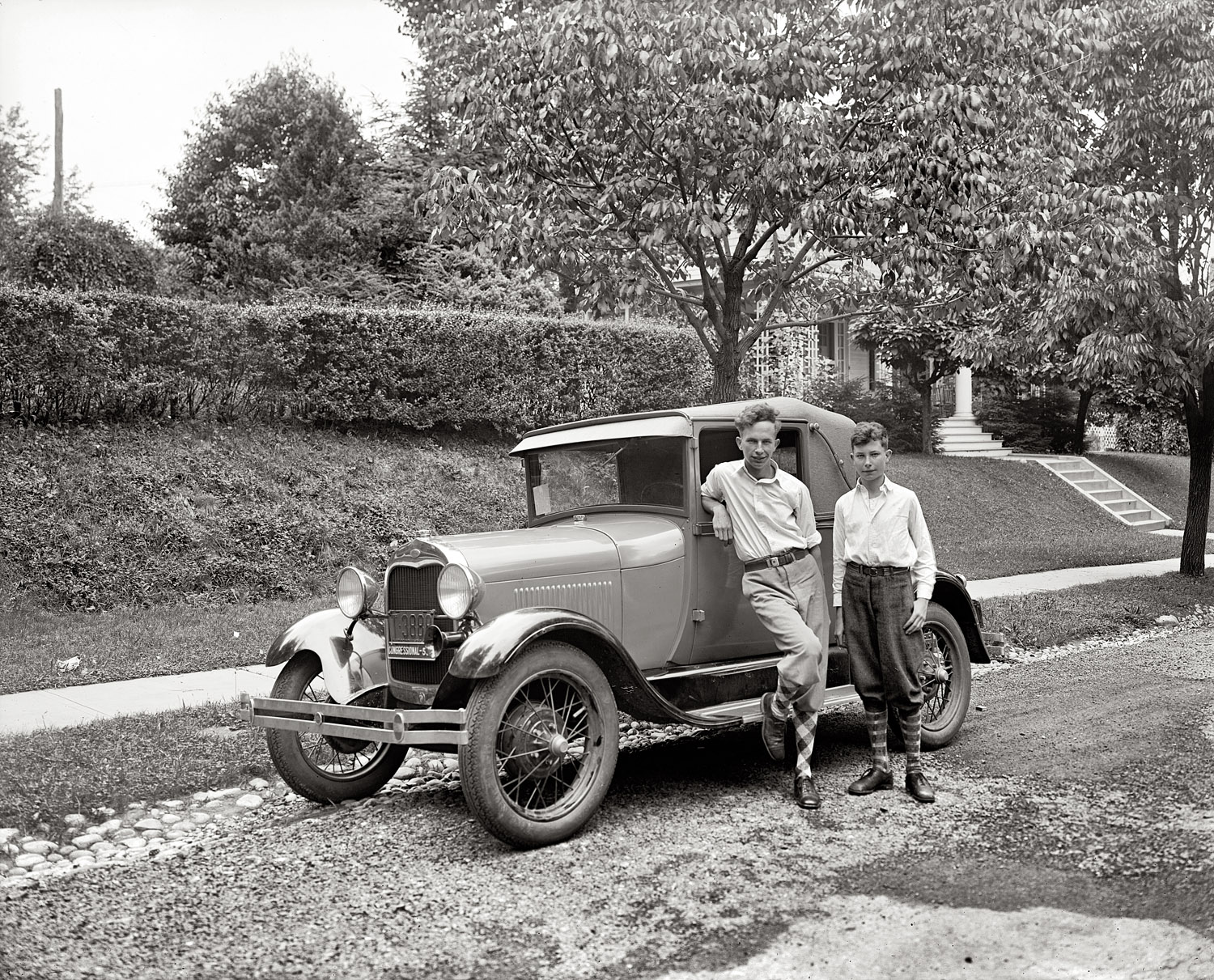 Washington, D.C., circa 1928. "Boys standing next to automobile." A Ford with congressional plates. View full size. National Photo Company glass negative.