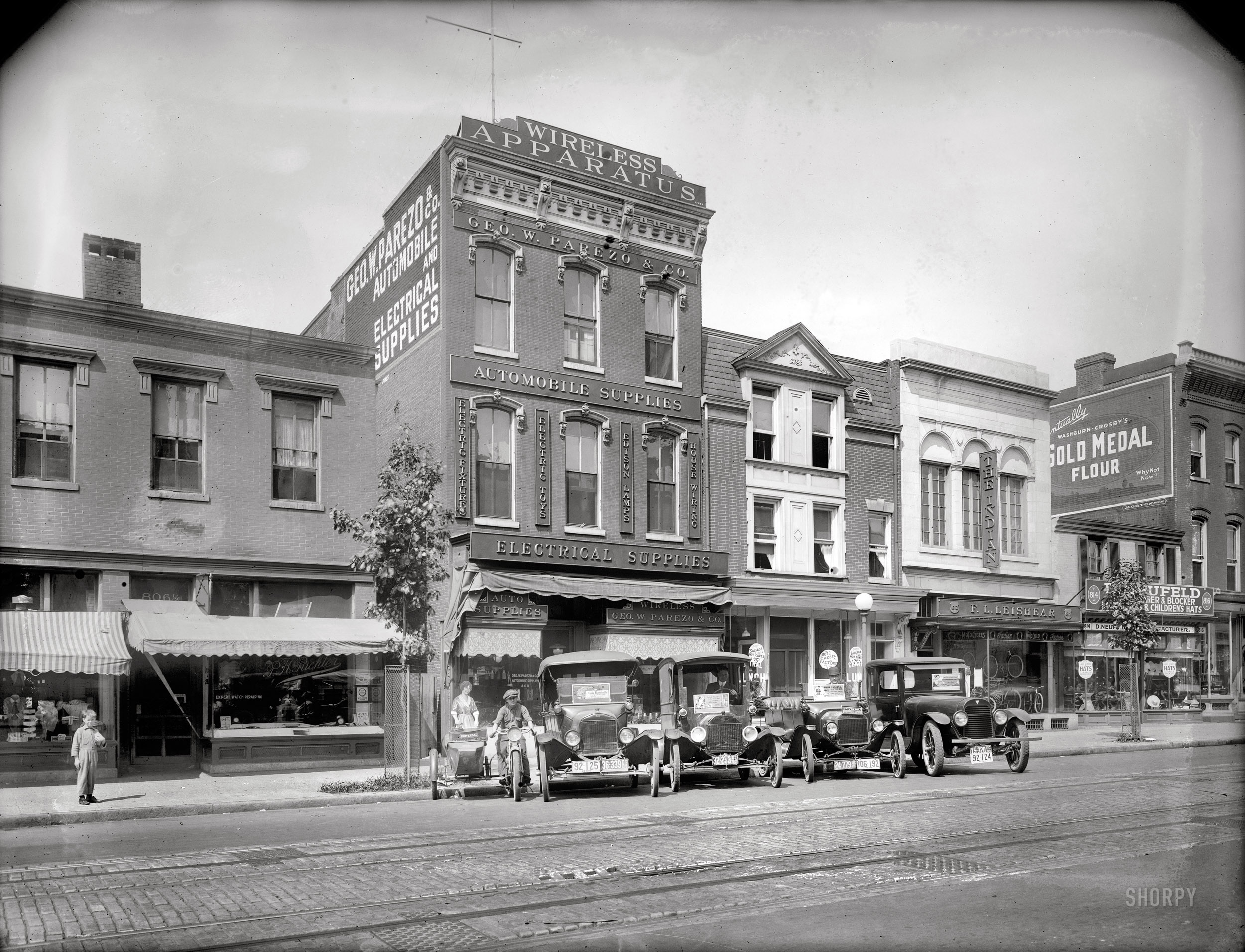 Washington, D.C., circa 1919. "George Parezo & Co., Ninth Street N.W." An electrical appliance store in the early years of that retail category (top sellers included irons, coffeepots, vacuums, table lamps and toasters), on the eve of the emergence of a new a mass communications medium. "Wireless" transmissions, at first mostly marine and military telegraphy, now included civilian audio broadcasts heard on crystal-set headphones. Before long loudspeakers connected to vacuum tube receivers entered the mainstream, and "radio" was born. National Photo Company Collection glass negative. View full size.
