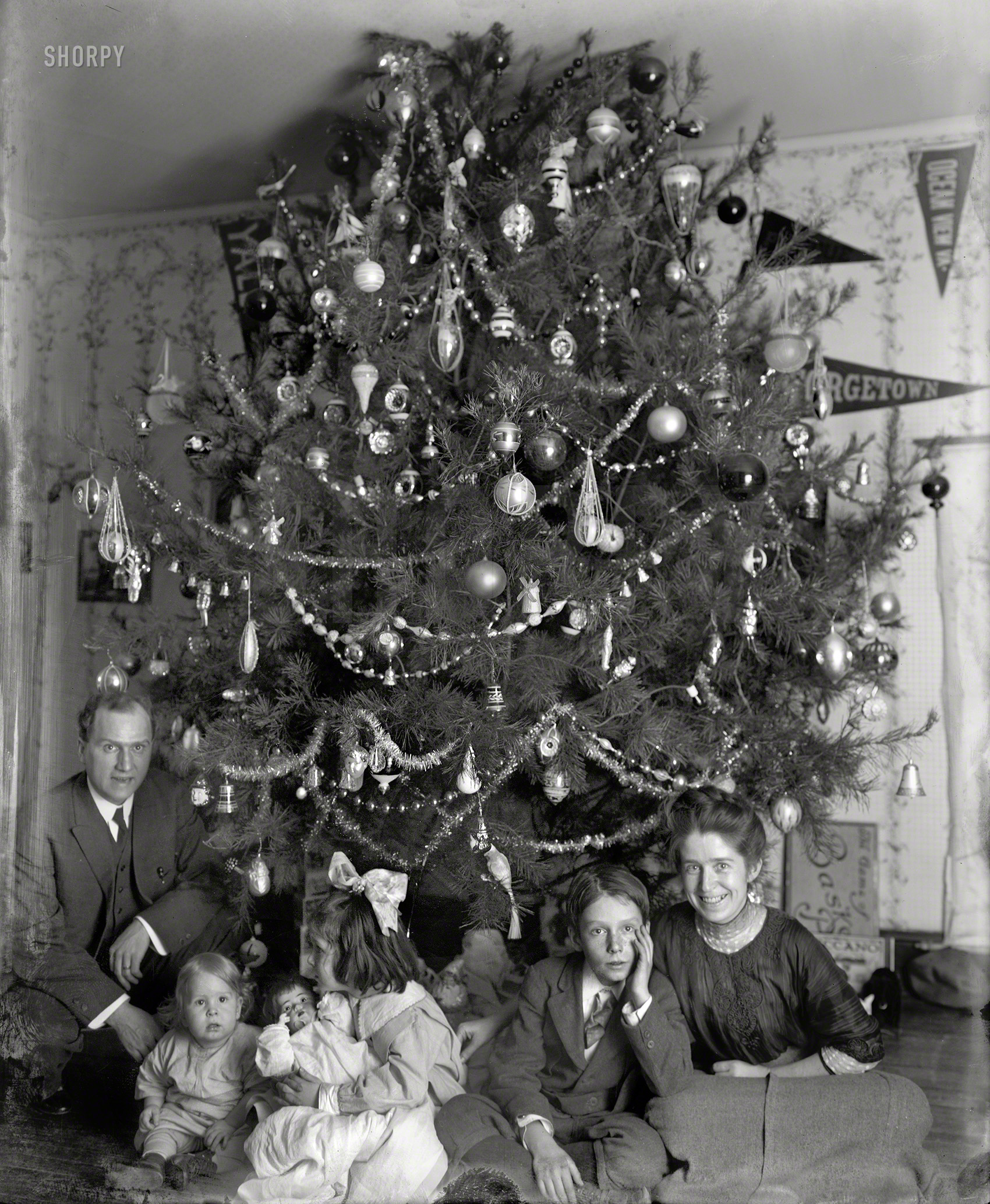&nbsp; &nbsp; &nbsp; &nbsp; Our ninth annual holiday greeting from the family of Washington lawyer Raymond Dickey, who has been welcoming us into his home since 1912 or 2008, depending on how you look at it. This marks the last of the series, unless we find some more in our stocking come Friday. MERRY CHRISTMAS TO ALL.
"Dickey family and Christmas tree, 1913." Looking a bit jollier than usual. National Photo Company Collection glass negative. View full size.