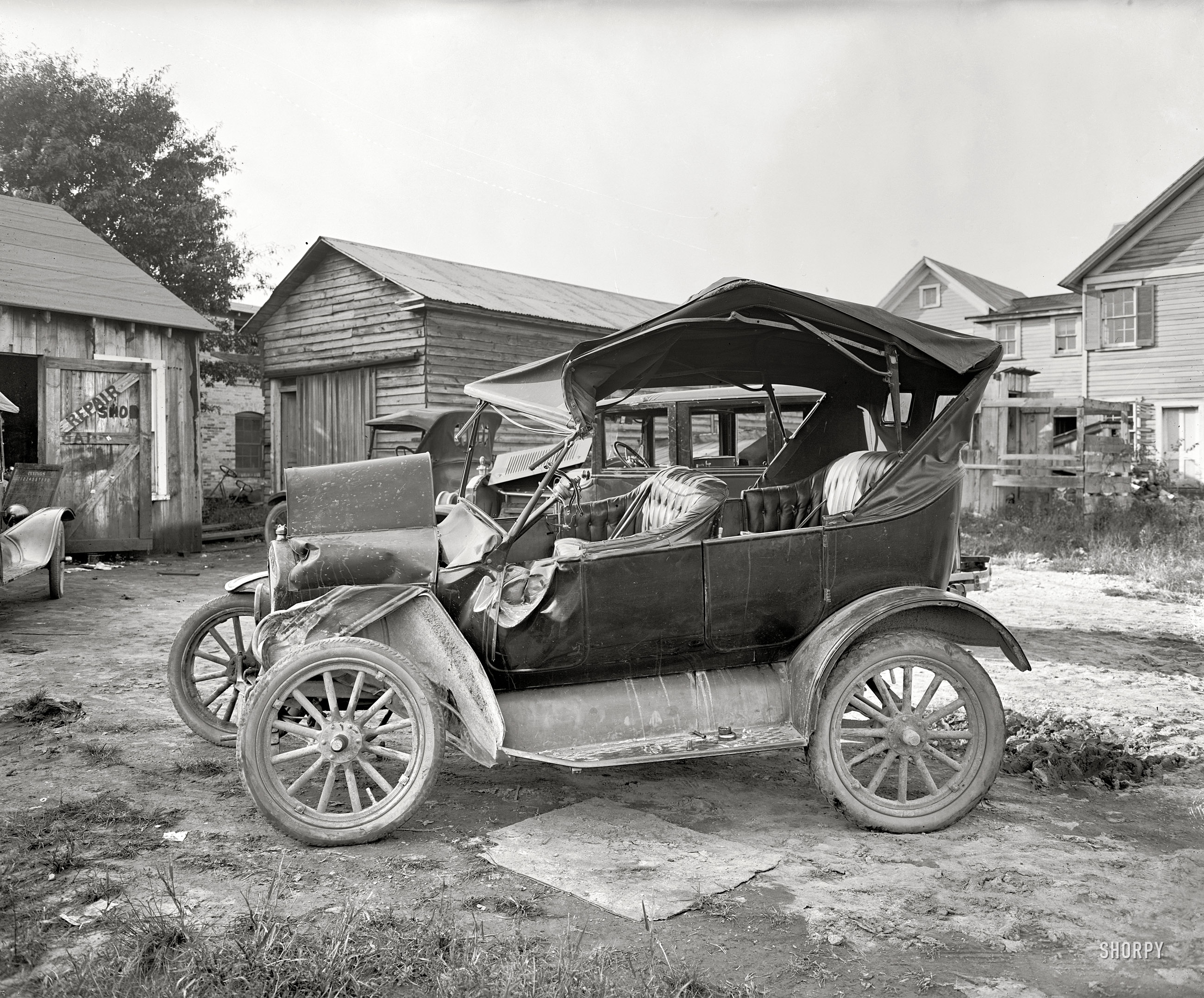 Washington, D.C., or vicinity, 1924. Exhibit C in the Case of the Battered Buick -- our third photo with the caption "Max Wiehle" and our second look at this tattered Model T, which we can now see is at a "Repair Shop Garage." Where the mechanics seem to be following the baseball scores. View full size.