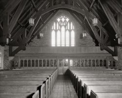 Washington, D.C., circa 1924. "Sanctuary, Chevy Chase Presbyterian Church." National Photo Company Collection glass negative. View full size.
AglowI like the light coming through the window.
Stock Church PartsJeez, do they use those same chandeliers in every church? They look like the same ones in the Catholic church I was dragged to as a kid in a small town in Iowa, and I recall seeing them in other other photos around here.
Man, that place would be hard to fall asleep in. Those brick floors look cold.
RevelationWow, what a gorgeous -- and bare -- sanctuary. Nowadays I guess you wouldn't get the exposed-beam-and-brick thing going on as much, but seeing the spine of the architecture is somehow gorgeous, despite being stark. 
Presbyterian PerspectiveThis photo provides the pastor's view, except that the congregation is missing. I wonder if the choir sang from the balcony above the narthex. 
If this church was traditionally aligned, the back window  faced west and the altar was on the east side of the sanctuary (behind the photographer.)
It's a lovely old church. I think it would be exceedingly rare to see that many massive wood beams in a church built today. Wood like that is expensive.
Weathered White OakI'm amazed in the following article on the design of this church no mention is made of the beautiful masonry.  From the photo it appears to be composed of a variety of rough dressed granite.


Washington Post, May 17, 1924 


Chevy Chase Church Dedication Tomorrow
Edifice Will Seat 700

...
The new edifice occupying a commanding site at the circle is of Tudor Gothic design.  The plans, as drawn by F.A. Nelson, architect of New York, were awarded the gold medal of merit at the exhibition of the Architectural League of New York in 1921.  The interior combines in rare beauty, the rugged strength of the walls and the roof of dark Southern pine.  Cathedral leaded glass is used in the arched stone windows.  The chancel furnishings of ornamental work, the narthex screen and pews are in weathered white oak.     The church, with balcony, seats 700.  Provision is made in the chancel for an antiphonal choir of eighteen voices, an organ console, elders seats and communion table, while in the assembly room under the auditorium there are seating accommodations for 500.
...

Today's view from the other side of the stained glass...
View Larger Map
Let there be lightAs a P. K., I've seen my share of church chandeliers.  This is, indeed, a very frequently seen design.  Church furnishings are meant to last a very long time, and are (or were in the past) quite well made.  Even the lower end of any sanctuary furnishing is usually expensive.  I imagine that the same basic design may have been used for a variety of budgets, with the difference in quality only visible on close inspection.  It's generally not easy to closely inspect chandeliers, but I imagine these were not the budget model of the day, either.
Someone I know used to sell church furnishings and supplies, among other things, and her employer carried the higher end.  If the pew flexes when you sit down midway between the supports, it's a cheaper model, and not one she would have sold.
P. K.:  Preacher's Kid
(The Gallery, D.C., Natl Photo)