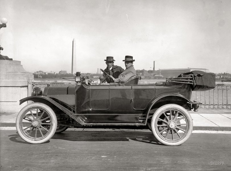 Washington circa 1914. "H.E.F. & A.W.L. in Detroiter." Herbert E. French, driving, was the owner of National Photo Company; "Artie" Leonard was one of its photographers. They're at the Tidal Basin on the Inlet Bridge, with the Washington Monument in back. National Photo glass negative. View full size.