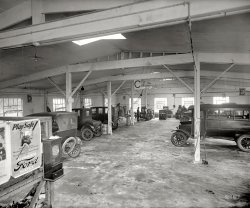 Rockville, Maryland, circa 1925. "Montgomery County Motor Co." Our sixth look behind the scenes at this car dealer. 8x10 glass negative. View full size.
Punching inI love the early time clock, which looks like an International Time Recording machine or a Bundy. Great shot!
Amazingly modern!The cars have changed far more in the past 86 years than the repair facilities!  This area could still be used effectively today!
(The Gallery, Cars, Trucks, Buses, Natl Photo)
