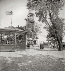 Circa 1925. "Arlington Beach." An amusement park in the general vicinity of today's Pentagon, removed in 1929 to make way for an airport expansion. National Photo Company Collection glass negative. View full size.
Crank it up to 11From the looks on the faces of the patrons, that has got to be the world's most boring Ferris Wheel.
Boring ferris wheelObviously the wheel has stopped. From the look of the guy on top, it has been a while. These days there would be an uproar over those two children alone.
In the Good Old SummertimeI notice when looking at our old family pictures going back to these halcyon days that so many of them are taken at beaches, amusement parks and picnics and the people always wore a lot of white clothing and straw hats.  Most apparently absent then was today's look of stress which seems to be ever present in many current candid shots.  Was it because leisure time really made them carefree or because they were not so worried about being robbed, assaulted and pillaged as we are today?  (And come on all you imaginative and inventive Shorpy commenters, this photo needs some commentary and story lines).   I must say I relish the variety of writing styles by the brilliant viewers just as much as I enjoy the appealing photography.  Don't just sit there, SAY something. 
Probably because it isn&#039;t moving...You can see that the leaves on the trees are blurry with movement, but the people on the Ferris Wheel are nice and clear.  This would seem to indicate that it isn't moving, and a Ferris Wheel that isn't moving is a pretty boring place...
&#039;Great Sound&#039;Quite the sound system on the Gazebo floor... bet the kids loved it and the parents hated it?
Warts and All

Washington Post, Jul 26, 1925 


Children With Warts to Compete at Outing

The more warts the merrier it will be for the underpriviledged boys and girls who go on the Gospel Mission's outing at Arlington Beach park next Sunday.  A handsome prize, donated by the park management, will be presented to the child showing the most of them.
About 200 kiddies will go on the trip.  John Newbold has donated four big vans with which to carry the children across the Highway bridge to the beach.  Other conveyances will also be used.  The run of the park will be given them when they get there. 
CC: GrandmaI was talking to my mother recently about her visit to the circus (Ringling Brothers) around 1934. My grandmother wouldn't let her have any cotton candy because "it was dirty." 
(The Gallery, D.C., Natl Photo, Sports)