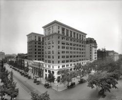 The Woodward Building in Washington circa 1923. The former office building, put up in 1911, became apartments in 2005. National Photo Co. View full size.
I wonder......if people in the 1920's lived happier lives overall than people do today.  Look at that picture.  The streets seem clean and pleasant. I bet that area is a mess now.
[It's not. - Dave]

A win for preservationists Washington Post, Mar 9, 1990


Court Bars Demolition of Woodward Building
Preservationists Hail Curb on "Special Merit"

Preservationists hailed a major victory yesterday when the D.C. Court of Appeals stopped plans to tear down a turn-of-the-century office building in the Fifteenth Street Financial Historic District.
The decision, the first to use the city's historic preservation law to overturn a demolition order issued by the mayor, placed new limits on the city's power to find that the "special merit" of a development justifies destruction of a historic site.
"Virtually every historic building will now have to pass a tougher standard in order to be torn down.  It will effect every single historic building," said Cornish F. Hitchcock, who represented the Committee of 100 of the Federal City, a private planning body that argued for yesterday's decision.
The stakes in the case were grander than its subject; The Woodward Building, a U-shaped beaux arts structure at 1426 H. S. NW. ....

(The Gallery, Cars, Trucks, Buses, D.C., Natl Photo)
