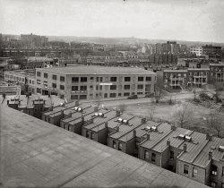 Washington, D.C., circa 1926. "Toward St. Albans from 2400 16th Street." National Photo Company Collection glass negative. View full size.
Ontario &amp; Tompkins GaragesThese news articles emphasize the modernity of the designs which avoid the need for car elevators.  Earlier this year I attended a fascinating presentation at the Library of Congress on the design history of parking garages.  A seemingly obscure topic but many advances in civil engineering arouse from the challenge of storing the suddenly numerous automobiles in 20th century cities.  A webcast of the presentation, by Shannon McDonald, is available.

Washington Post, Sep 17, 1922

 New Ontario Garage leased my Menefees
The new Ontario garage, at the corner of Seventeenth and Kalorama road northwest, built and owned by David S. Hendrick, has been leased for a term of years to F. Menefee &amp; Sons, according to announcement made yesterday by the office of Morris Cafritz &amp; Co., Inc., the firm which handled the transaction.
No expense has been spared by Mr. Hendrick in making this building one of the largest and most modern garages in the city.  The construction is of reinforced concrete, steel and hollow tile  The building is two stories high, with street entrances on both Seventeenth street and Kalorama road, thus doing away with elevators.  The capacity will be 250 cars, with ample stall and aisle space, and the plant will be a great help in relieving the garage shortage in the Mount Pleasant section.
The arrangement of the show room, retail room and gas station is such that service can be given without confusion.
The building has a frontage of 152 feet and a depth of 150 feet and is 181 feet on the diagonal.  It is heated by steam and is well ventilated.  The electric light fixtures are so arranged that an excellent distribution of light is given throughout the building.  Several unique ideas have been installed by F. Menefee, Jr., who, until recently, was identified with the automobile business in the middle West.

Washington Post, Oct 14, 1923

 Grade bans elevator in new structure
The automobile service building located at the northwest corner of Seventeenth street and Kalorama road is about ready for occupancy.  This strictly fireproof building is one of the largest buildings of this character in the city.
There is a total of 62,000 square feet of floor space on three floors.  Because of the size of the building and because of the streets and alley adjacent, it is not necessary to have an elevator for access to any of the floors.  Two large doorways provide an entrance on Kalorama road to the first floor.  Access to the second floor is through two large doorways just of Seventeenth street, and access to the third floor is obtained by a slight ramp from a wide public alley.
...
The building is owned by Charles H. Tompkins and was designed and constructed by the Charles H. Tompkins Company, construction engineers.

War of the WorldsWhat's that structure on top of the ridge in the distance, at about 2/3 of the frame from the left? A Tripod avant la lettre?
Tompkins GarageThis is great. Now I know where to take my Oakland when it starts acting up.
And on Mt. St. AlbansThat bump on the horizon is the apse and choir of the National Cathedral, then just barely started construction.
Lincoln WindowsI see "Lincoln," just wondering what's below it. Did they sell/service Lincoln cars or welding supplies?
["Lincoln Service Station." - Dave]

Modular ConstructionThe building in the near foreground looks almost modular with a succession of identical appendages on each identical roof section. Does anyone know the function of this building?
[Those are rowhouses with skylights. - Dave]
Aha!I thought garage was repair shop and could figure out why they needed multiple floors.  But they are parking garages?  Seems like mostly residential row houses though so did they park their cars in the garages overnight?
These old photos have such fascinating detail!
[Not a parking garage. - Dave]
Still NeighborsMany of the buildings in the photo still exist.  The Tompkins garage has one story more and the Packard and Ontario garages are still there.  In the background, the apartment building with the small dome and the one to its foreground are around as well.  The last two being on Columbia Road.
Oh, my old neighborhood!The street of houses beyond the Tompkins Garage looks to be the 2400 block of Ontario Road -- I used to own a house in the 2300 block (would be to the left of this photo.)  The Ontario Garage is now condominiums, and the big dirt patch on the right side of the photo is now where the Harris Teeter store is, which was originally an armory and then a roller skating rink.
View Larger Map
(The Gallery, Cars, Trucks, Buses, D.C., Natl Photo)