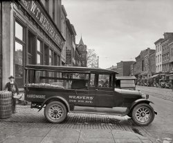 Washington, D.C., 1926. "Semmes Motor Co. -- Weaver truck." And, perhaps, Mr. Weaver. National Photo Company Collection glass negative. View full size.
GeorgetownThe neighborhood has changed a bit, but a W.T. Weaver &amp; Sons sign still hangs on Wisconsin Avenue in Georgetown at what appears to be the same location judging from the buildings across the street.
View Larger Map
1208It appears that 1208 has been replaced (as well as two buildings across the street). The alley is in the same spot and the turreted building up the street is unchanged except for a lick of paint..
Must be upstairshttp://www.weaverhardware.com/
More help!This photo is another example of Shorpy assisting me in my model railroading.  I wondered whether or not chain link fencing would be appropriate for the era of my layout (set in 1941).  Well, looky there -- chain link fence gates in the back of the truck.  And 15 years before "my" time.
W.T. WeaverThe store was renovated into a Bennetton store in the late 1980s or early 90s. There is still a small second floor showroom for architectural hardware, fittings and such operated by W.T. Weaver, in keeping with the definition of "hardware."
(The Gallery, Cars, Trucks, Buses, D.C., Natl Photo)