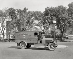 Washington, D.C., circa 1926. "Semmes Motor Co. -- Gelfand's truck." There is of course dignity in all work. But still, I'm glad I don't have to tell people that "I drive the mayonnaise wagon." National Photo glass negative. View full size.
&quot;Say cheese&quot;And doesn't he look pleased about having his photo taken?
Servicing the Mayonnaise TruckWhen it was time for a valve job, would they take it to the Mayo Clinic? 
UnmodernizedNot sure if I would want that title either, but this was in the day when grocery stores would get individual deliveries, opposed to what we have today where one truck pulls up and has everything on it.
Mama always said"You gotta watch out for the mayonnaise man."
I Drive the Mayonnaise WagonYou wouldn't have to tell them anything, David. The things you do to keep body and soul together are none of their business.
Gelfand&#039;s Mayo

Washington Post, Oct 16, 1925 


The Home of Gelfand's Quality Products

Fifteen years ago while conducting a delicatessen stand in Lexington Market, Baltimore, Simon Gelfand prepared Mayonnaise from a special recipe for the customers who patronized his store.  The product sprang into instant popularity.
Today Gelfand's Mayonnaise is made in a modern factory, flooded on all sides with sunlight surrounded by a well kept lawn in the suburbs of Baltimore.  Automatic machinery draws the olive oil as it arrives in tank cars, mixes the product, fills, caps and labels the glass jar containers.
To insure the utmost cleanliness and healthful conditions, employees of the factory are required to undergo medical examinations at stated intervals, each employee is furnished with a clean uniform daily, and shower, baths and recreation rooms are provided.
Distributing branches for Gelfand's products are located in points as far west as Los Angeles, as far north as Boston and Detroit, and as far south as Tampa, Fla.  Harry Carpel, with headquarters in Washington, conducts branches in Philadelphia, Boston and Pittsburgh.  Mr. Carpel has been associated with Mr. Gelfand since the founding of the business.
Mr. Gelfand is now preparing for a trip to the coast where he is going to make arrangements for the establishment of a branch factory, to take care of the rapidly growing business out there.  A branch is necessary because of the inconvenience of shipping in carload lots from Baltimore.




Harry L. Carpel Obit
Washington Post, Jul 18, 1956 


Harry L. Carpel, Food Merchant

Harry L. Carpel, pioneer Washington food distributor, who continued in business and public life though stricken blind six years ago, died yesterday.  He was 60.
Mr. Carpel who often put in 14 or 16 hours a day traveled frequently to Chicago, Florida and Georgia to conduct his business.
In 1917, he was one of the first to distribute package cheese and mayonnaise, which was made in Baltimore.  In 1938 he started marketing the Carpel brand of frozen foods.
Mr. Carpel fought a diabetic condition for 20 years before his eyesight began to dim.  He became totally blind in 1949.  He said that the loss of his sight only sharpened his memory.
He became well known for his charitable acts.  He loaned money to many small grocery men to get them started in the business.  He was a sponsor of the Albert Einstein College of Medicine at Brandeis University and Haifa Institute of Technion in Israel.
In March, 1954, he was honored at a testimonial dinner by friends of Bar Ilan, a university in Tel Aviv.  The university presented him with a scroll symbolizing the dedication of the Harry Carpel Building of Chemistry. [It's still there!]
After losing his fight against blindness, Mr. Carpel sold the controlling interest in his business and began to move toward a forced retirement. But within a few weeks he went back to work for the new owners and in September, 1953, he repurchased his controlling interest and went back to work as owner and chief executive. Mr. Carpel explained it saying, he had too much time on his hands.  He said he learned it didn't pay to quit.
He is survived by his wife, Anna; two sons, Albert J. of Chevy Chase, and Jack of Washington; two brothers, Samuel L. and Joseph M. Carpel, both of Washington; two sisters, Rose Geller of Washington and Sophia Gumenick, of Richmond, and five grandchildren.
Funeral services will be held at the Beth Sholom Congregation, 8th and Shepherd sts. nw., Thursday at 1 p.m. Burial will be at Beth Sholom Cemetery.  The family asks that flowers be omitted.
The truckGraham Brothers.  
Submarine sandwichRemember when Harry Carpel drove the truck into the Potomac? It was Washington's first Sinko de Mayo.
I Hate MayoEver since the day (I was about 9) that I swallowed (but not for long) a HUGE tablespoon of what I THOUGHT was Marshmallow Creme, just the thought mayonnaise is ghastly enough to make me profoundly ill.  It's taking effect just by writing this. The picture of this truck takes it to a whole new level. 
If I taped a picture of the Mayonnaise Wagon to the fridge, I could cut down my food costs by roughly 100%.
Mr. Carpel was also honored... with an underground passage between the Harry Carpel Building of Chemistry and another campus laboratory. Surely you've heard of the Carpel Tunnel.
(The Gallery, Cars, Trucks, Buses, D.C., Natl Photo)