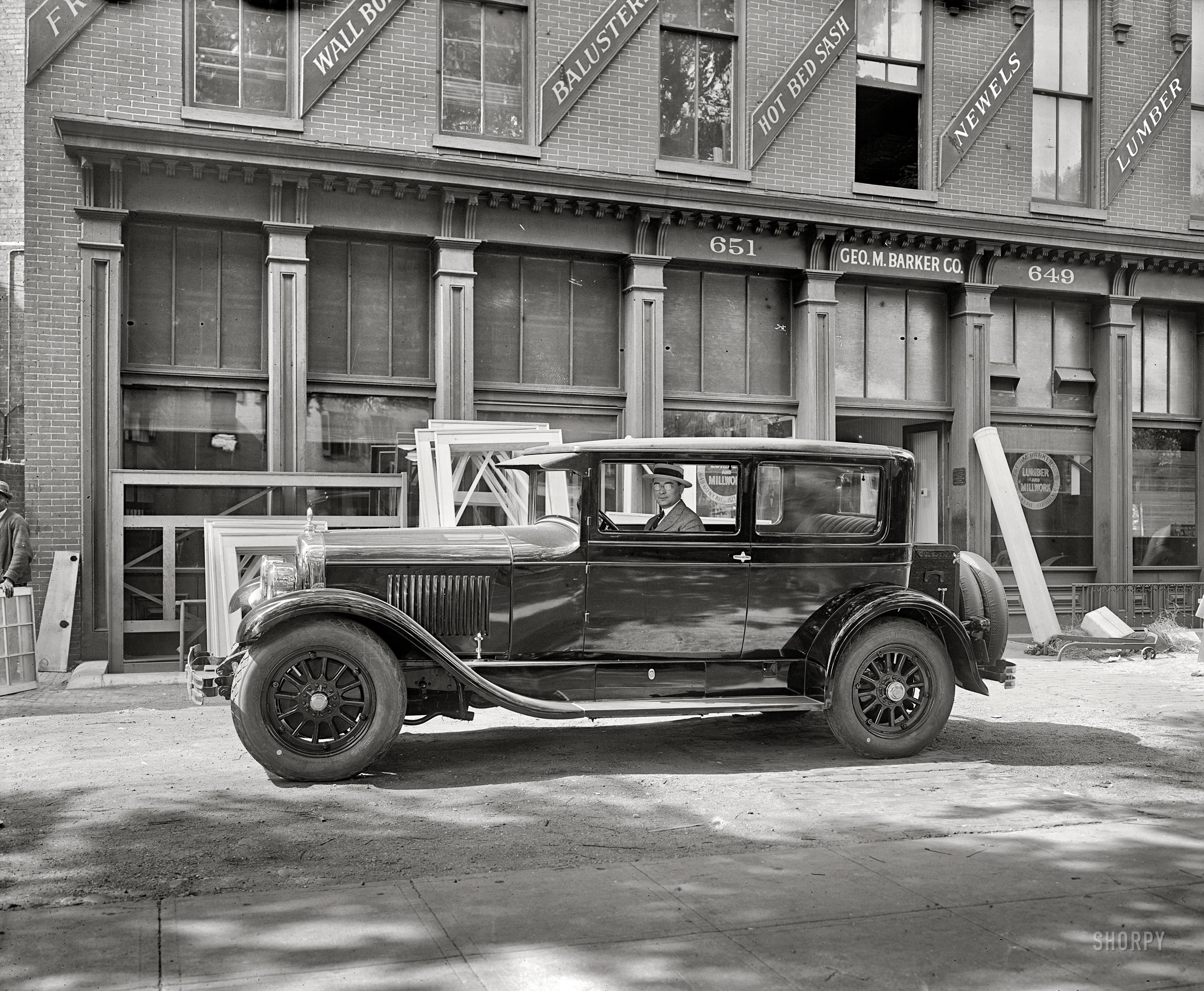 Washington, D.C., circa 1926. "Washington Cadillac Co." A glossy new Cadillac in front of Barker Lumber, your headquarters for newels, balusters and "hot bed sash." National Photo Company Collection glass negative. View full size.