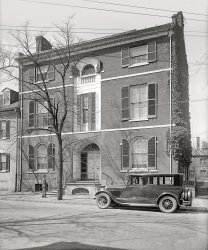 Alexandria, Virginia, circa 1926. "Dr. Fairfax home (Ford Motor Co.)" From a series of photographs, taken for Ford Motor Co., showing Alexandria landmarks. The car here is a Lincoln. National Photo glass negative. View full size.
SimpleVery nicely done entry recess, but those shutters on the top really jar the eye.
Harry LeePleasant surprise seeing this pic. I just found a few days ago this person is a relative. Thanks for sharing!
Federal StyleLovely Federal (or is it Georgian?) style architecture!
Things probably only a carpenter sees...It appears this was a time when shutters were becoming more decorative than functional. Telltale signs of non-use are the bird droppings and needed repairs, plus there are no knobs or latches to hold them shut if they were closed. And that broken piece of lumber along the roof edge raises a few questions about why it's there, what or who broke it off, and how does the bent gutter work into the mystery? And only one screen, second floor left window? 
Time stands stillI live a couple blocks up from this home, and aside from a much more lush garden on the right side yard, it looks identical to this photo. Being over 100 years old, the exterior is protected from being modified. What's more, the present owner signed the paperwork so that the interior woodwork, mantels, etc. are likewise protected from being "updated" by future owners.
HardwareI'm seeing all kinds of hardware for holding the shutters in the hi-res version of the picture.
[Another thing: The tall righthand middle shutter moved during the exposure. - Dave]
+89Below is the same view from October of 2015.
(The Gallery, Cars, Trucks, Buses, Natl Photo)