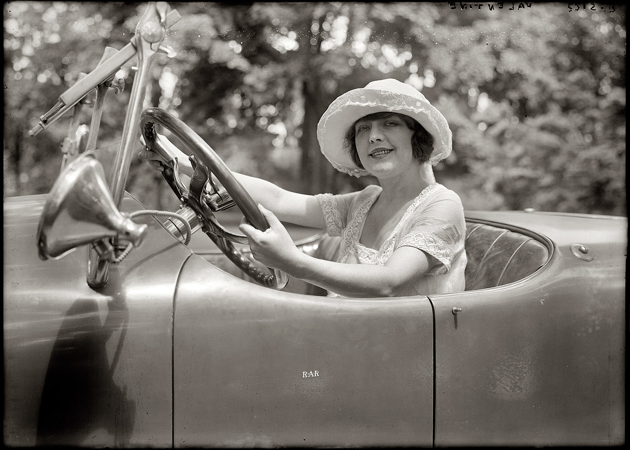 The film and stage actress Grace Valentine circa 1920 at the wheel of an enormous roadster. View full size. 5x7 glass negative, George Grantham Bain Collection.