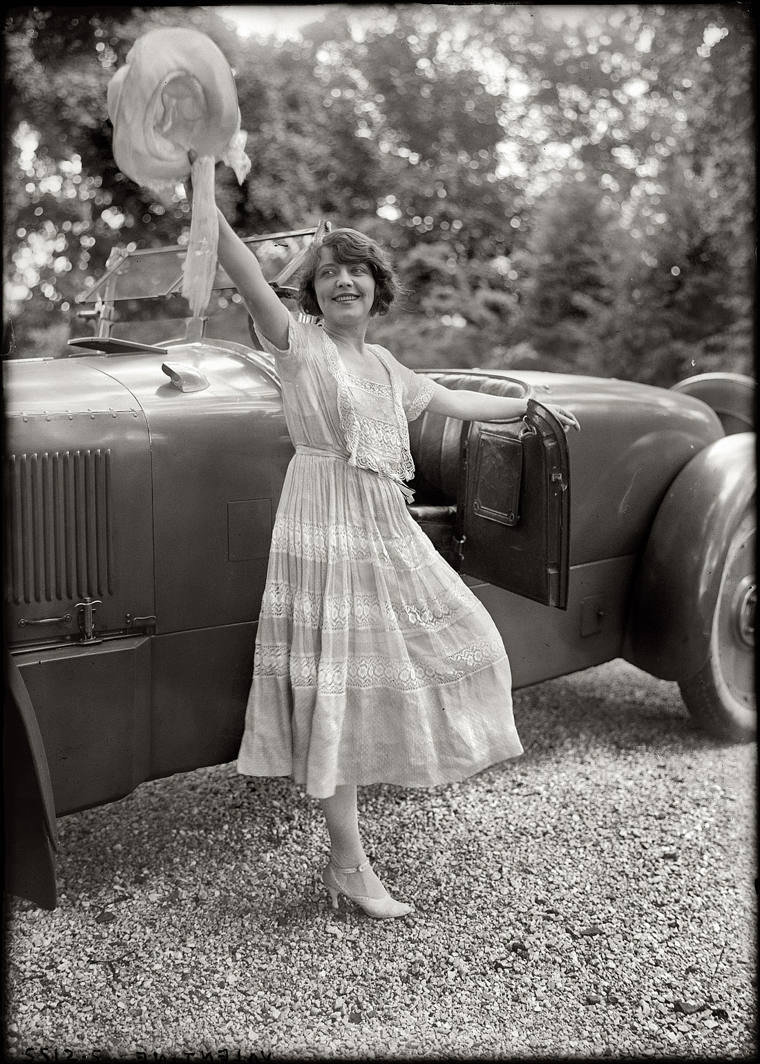 Another circa 1920 shot of the stage and film actress Grace Valentine and that Packard Twin Six roadster. Starting in 1916, Grace was one of the players in a Vitagraph film serial called The Scarlet Runner, about young Christopher Race and his "super car," the Scarlet Runner. (The final installment of the 12 two-reel episodes was "The Car and the Girl.") While unfortunately no prints of the film are known to survive, the story still exists on paper, having been serialized in newspapers of the day. View full size. George Grantham Bain Collection.