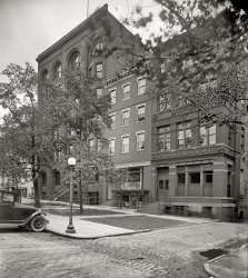 Washington circa 1925. "Tepper Building, Standard Engraving Co., 470 Louisiana Avenue N.W." The Tepper family business is what you might call vertically integrated: Joe's law practice upstairs, above Saul's "Notions, Hosiery, Underwear." National Photo Company Collection glass negative. View full size.
Two for OneGet defended and hosed at the same time!
(Does George Washington live next door?)
HeadsThose two heads peering out of the Estes Building entrance give this photo a certain creepy effect.
[Plus the three ghosts outside. One is wearing pumps. - Dave]
Long goneLouisiana Avenue in the northwest quadrant of DC is just a short 3-block segment running from Constitution Avenue to Union Station, a stone's throw from the Capitol.
&quot;Legal Briefs&quot;may be the very best of Dave's pun-ishments of Shorpy viewers!
Keep 'em up!!
[So to speak. - Dave]
Tax BrassSign over the entrance to the building on the left: "Bureau of Internal Revenue," now known as the IRS.
1925 EssexThe car parked at the curb is a Second Series 1925 Essex 6 Coach, built after March of that year. Essex pioneered the first low priced closed car with the introduction of its five-passenger Coach in 1922, which was an immediate success. The 1925 Essex was the first closed car that sold for the same price as an open touring car. By October of '25 you could buy one of these cars for $765, which was only $105 more than the price of the Ford Fordor Sedan. Essex sold 159,634 cars in 1925.
The old Louisiana AvenueBefore 1933, this block of Louisiana Avenue was adjacent to Judiciary Square - here it is on a 1911 map:

The section of Louisiana south of Pennsylvania Avenue was built over during the construction of the Federal Triangle, prompting Louisiana senators to argue that the remaining, smaller road was an affront to their state's dignity (see "Fight Over Name of Thoroughfare Will Be Vigorous", 11/28/30 Washington Post).  
The name was being applied in its current location by 1933.  The remaining stub of Louisiana became part of Indiana Avenue NW.
The city bought the Tepper Building in December 1932 and condemned it to make way for the never-completed Municipal Center complex.  I'm not sure when it was finally razed, but it's definitely gone now. 
Death and taxesThe building at left--462-464 Louisiana Ave., occupied here by the Bureau of Internal Revenue--housed the Army Medical School until its relocation to Walter Reed in 1922.
(The Gallery, D.C., Natl Photo)