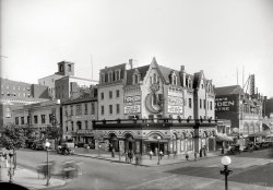 Washington movie houses circa 1918. "Crandall's Theater, 9th &amp; E Streets N.W." Now playing: Madge Kennedy and Tom Moore in "The Kingdom of Youth." National Photo Company Collection glass negative. View full size.
Fantastic PhotoThe building, signs, soldiers and cars all add up to a great shot for browsing. 
Haunting ViewI love the Gothic Revival upper windows of Crandall's Theater.  Those mysterious arches and curves are very intriguing.
Harry&#039;s JoyLots of entries in the index of Robert K. Headley's Motion Picture Exhibition in Washington, D.C. for Harry Crandall, who opened his first theater, the Casino, in 1907.
Shorpy's image is reproduced on p. 38 of Headley and identifies it as the Joy Theater (opened in 1913, "usually simply called Crandall's"); the caption also notes Tom Moore's "massive" Garden Theater to the right in the image, down 9th Street.
The Joy was Harry Crandall's springboard to the top of the Washington movie ladder.  He spent $25,000 to build the Joy in what had been a four-story building that housed a haberdashery....  The floor was red concrete and sloped to the front... so that it could be flooded every night after the theater closed; it was believed that a complete flooding would keep the theater absolutely sanitary.
Seating about 450, the Joy was in operation only until 1924, when it was converted back into retail space.
Madge KennedyHow exciting to see!!!!! I was friends with Madge a few years ago!!!!!
[Madge died 21 years ago at age 96. She played Aunt Martha on "Leave It to Beaver." - Dave]

Madge &amp; TomThe stars of this early silent drama both had extraordinarily long careers in the business lasting into the television era. Madge Kennedy actually appears in an episode of "The Odd Couple" from 1972!
How do we know that Irish-born actor Tom Moore owned that DC theater?
[Good question. Theater impresario Tom Moore and actor Tom Moore seem to have been two different people, so I zapped that from the caption. - Dave]
Black streetlightWhat is this object?  Looks like a blacked-out streetlamp...
[A fire alarm call box. The globes on these were usually red. - Dave]

Let&#039;s All Go to the DentistAfter heading to the lobby to grab yourself a few snacks, make sure to check out the dentist located smack dab in the middle of all the fun. I guess if you were a dentist in 1918, you had to get your business somehow. But they don't need to worry, with "SODA" proudly displayed below the dentist's office, they'll be back.
[Right next to "Dikeman's Orange Beverage." - Dave]

Movie Palaces and Dental ParlorsNoticing the dentist between the movie theaters, remember that one of the greatest silent films, "Greed," is the story of a dentist -- who, like Washington's Dr. Fitzgerald, called his office a "dental parlor." It would be interesting to know if "Greed" played in either of these downtown theaters in 1924.
Roof TanksSeveral years ago I worked in a nine-story warehouse built in 1899. It still had a large water tank on the roof that was for the fire sprinkler system. The tank was filled by huge pumps in the basement. Due to the historic preservation laws here in Portland, Oregon, the tank had to be maintained, but not filled with water. The original pipes and pumps were disconnected. The fire system had been upgraded in the late 1950's to a newer system and most of the old copper pipes were left in place. When the building was converted to condos a couple of years ago,they pulled out all of the old pipes and left the tank on the roof.
Heads Up!Note the rooftop water tank above the Lansburgh &amp; Bro sign. The penthouse of that building is devoted to that huge water bucket. I presume these would be filled with rainwater at no cost and supply buildings with non potable industrial water supplies.
[Interesting theory -- but how would you fill a cistern on top of a building with rainwater? (Verrry slowly.) This water tank on top of the Lansburgh department store is either regular drinking water or a standpipe tank for firefighting. Back in the day, most buildings taller than six or seven stories had penthouse water tanks, and they're still a familiar sight on older apartment buildings in big cities like New York. A lot of modern office towers have them too, although they're usually concealed. - Dave]



An early 80s ghostThis building lingered into the early 80s, though it was barely recognizable by then:

The upper floors were sheared off in 1961, and a series of low-rent tenants moved in.  One of the last was an adult book store / peep show.
(The Gallery, Cars, Trucks, Buses, D.C., Movies, Natl Photo)