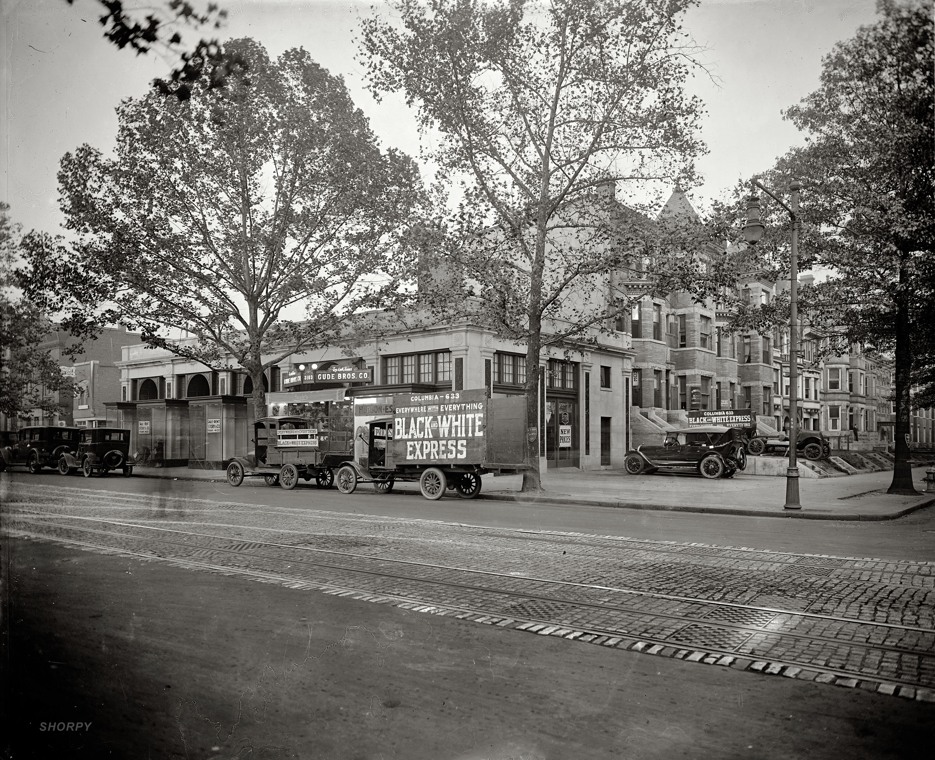 Washington, D.C., circa 1926. "I.C. Barber Motor Co., 14th & Irving Streets N.W." Here we have everything from a Hudson-Essex car dealership to moving vans to a florist to "scalp specials." And not only ghost pedestrians in this time exposure but a ghost car! Also note the use of trees as 1 Hour Parking signposts. National Photo Company Collection glass negative, Library of Congress. View full size.
