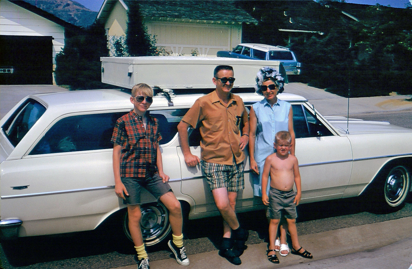 Leaving Walnut, CA for Wyoming and Nebraska in July 1969. I'm on the left, trying to look cool, going to start high school in the fall. Yikes, those socks!

There's my Dad and Mom, who appeared in earlier pictures. They're showing some age progression. Both are in their early 40s here. My little brother was a surly bundle of anti-joy then, and he whined a lot through the whole trip.

We packed up the '64 Chevelle wagon and left for the great unknown. As a surly teen, I read a lot of books along the way and grunted and moaned a lot. During the trip, we heard about the Charles Manson family murders in Los Angeles, and being only 30 or so miles away, I was really scared to come home.

It all worked out ... thanks for looking and I look forward to your comments. View full size.