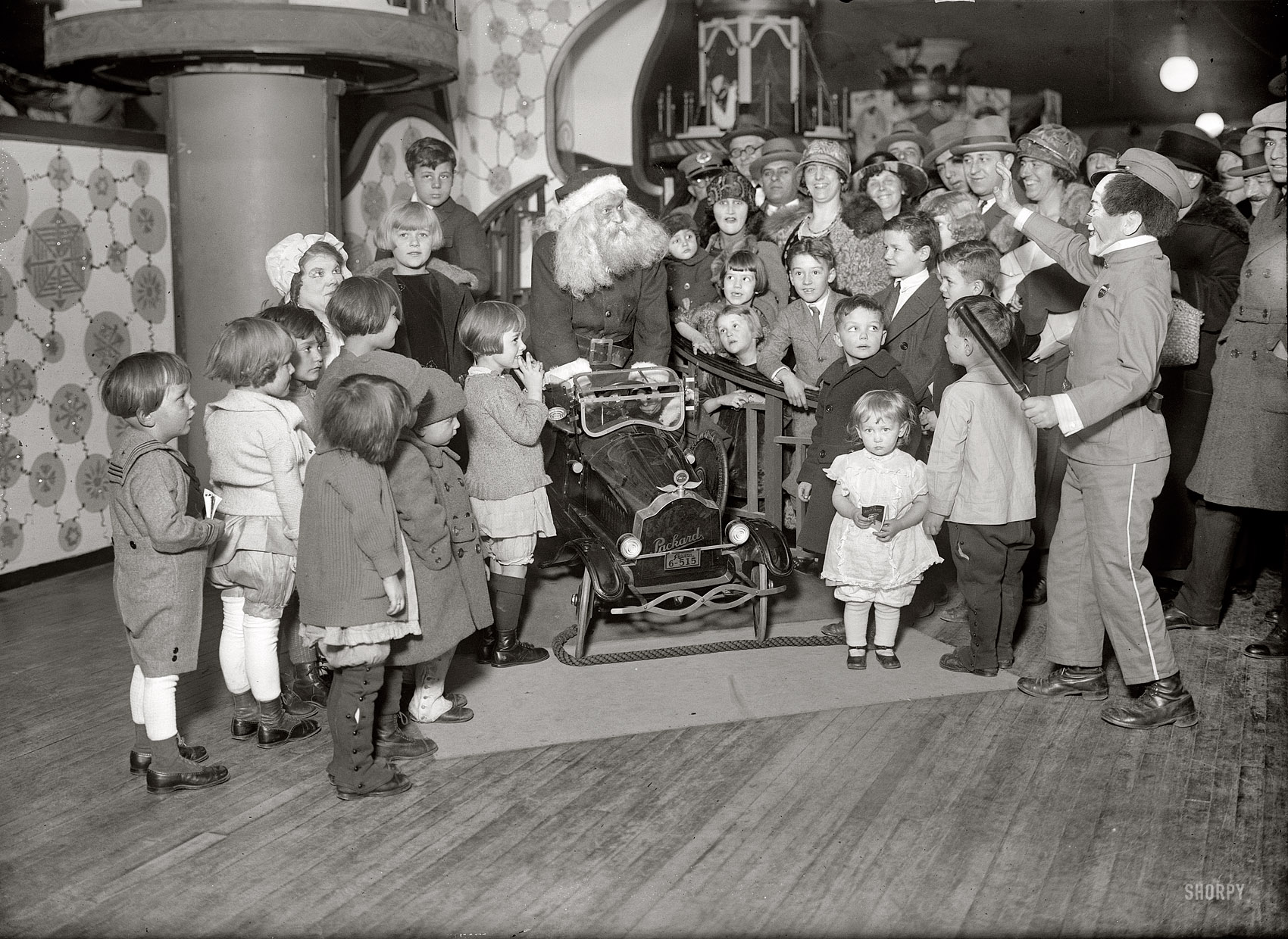 December 1924. "Santa's toys." Toy World at Wanamaker's in New York. Be nice, boys and girls, and you might get a Packard! Be naughty and you might get arrested! 5x7 glass negative, George Grantham Bain Collection. View full size.
