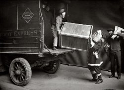 New York, December 1924. "Unloading Railway Express car." When the sleigh's in the shop, Santa might have to hijack a truck. 5x7 glass negative. View full size.