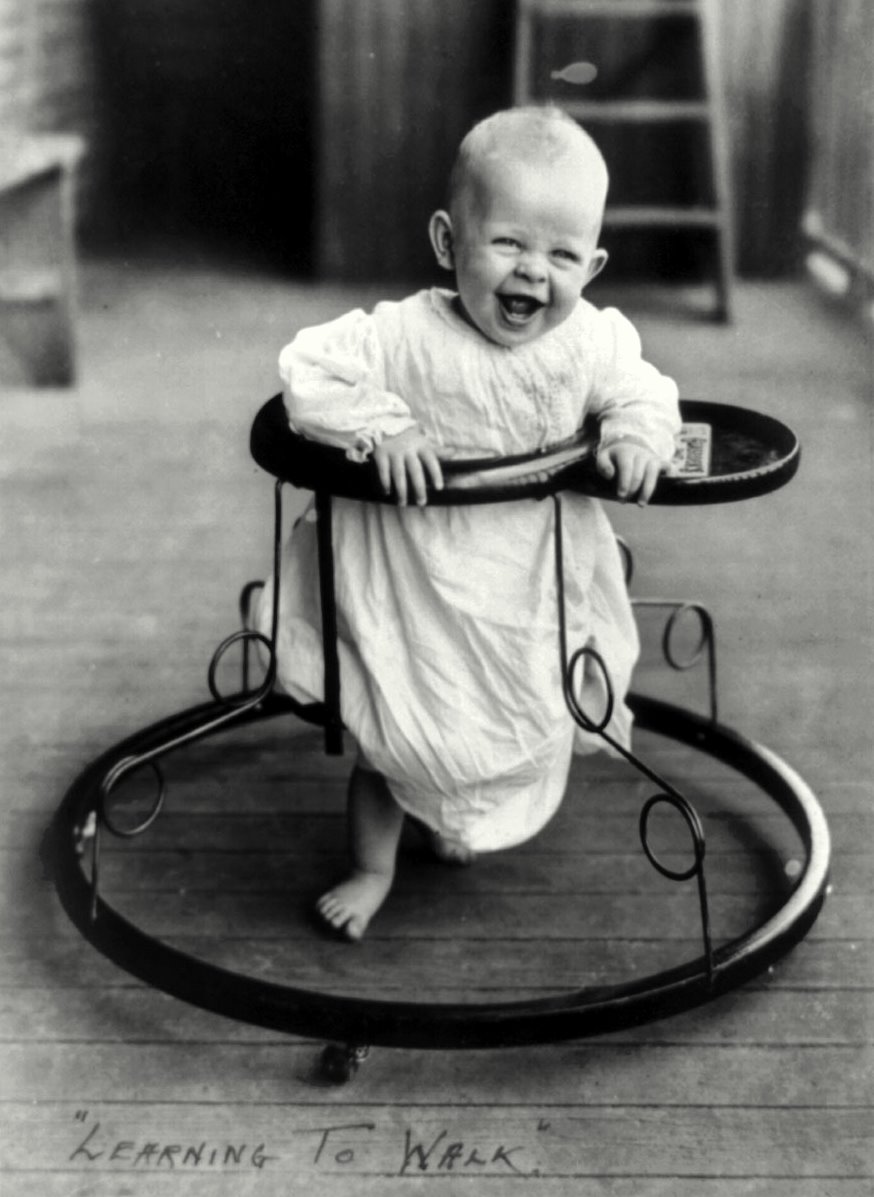 A joyful baby takes a spin in a walker in 1905. View full size.