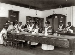 Ten women in a cooking class at the Hampton Institute in Hampton, Va. Photograph by Frances Benjamin Johnston, c. 1899. View full size.
